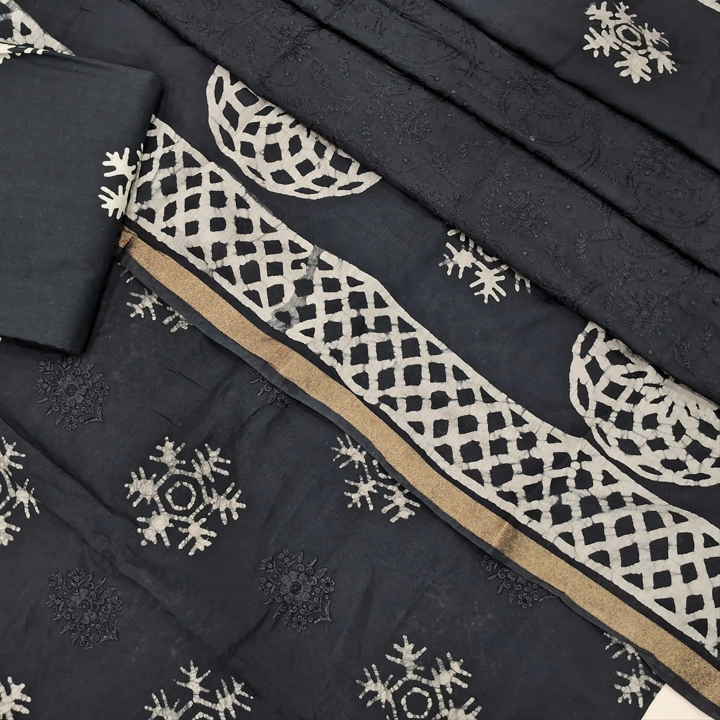 Black premium silk cotton unstitched salwar material(lining needed)self embroidery work on front, batik design all over, wax batik cotton bottom, self embroidery and batik design on silk cotton dupatta with tissue borders.AP262212