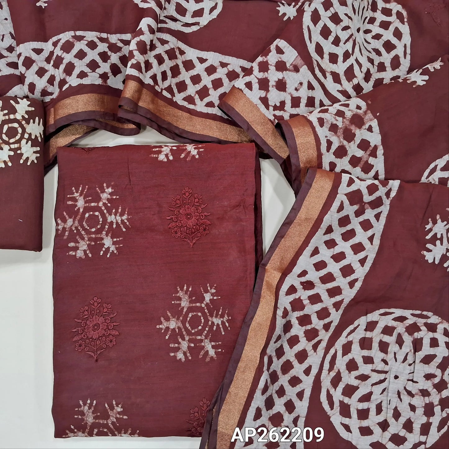 Dark maroon premium silk cotton unstitched salwar material(lining needed)self embroidery work on front, batik design all over, wax batik cotton bottom, self embroidery and batik design on silk cotton dupatta with tissue borders.AP262209