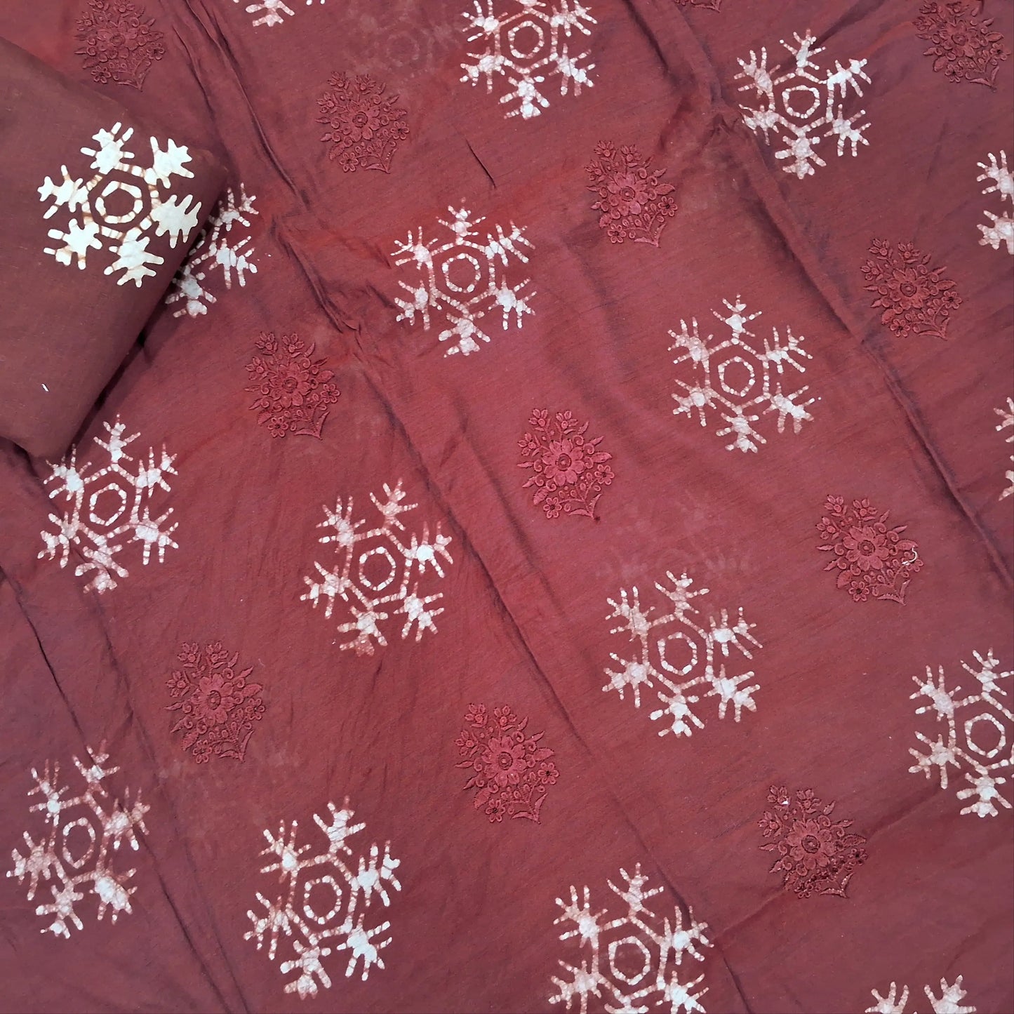 Dark maroon premium silk cotton unstitched salwar material(lining needed)self embroidery work on front, batik design all over, wax batik cotton bottom, self embroidery and batik design on silk cotton dupatta with tissue borders.AP262209