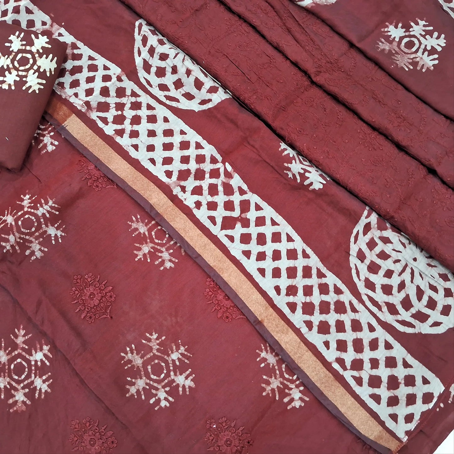Dark maroon premium silk cotton unstitched salwar material(lining needed)self embroidery work on front, batik design all over, wax batik cotton bottom, self embroidery and batik design on silk cotton dupatta with tissue borders.AP262209
