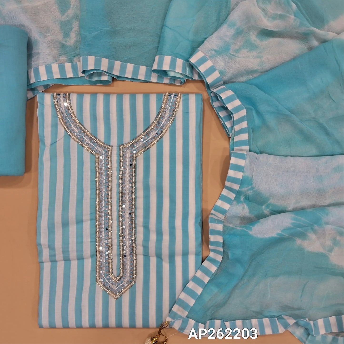 Pastel blue vertical printed pure soft cotton unstitched salwar material, sugar bead, faux mirror and cut work on yoke, (lining needed)drum dyed cotton fabric provided for lining, NO BOTTOM,shibori dyed pure chiffon dupatta. AP262203