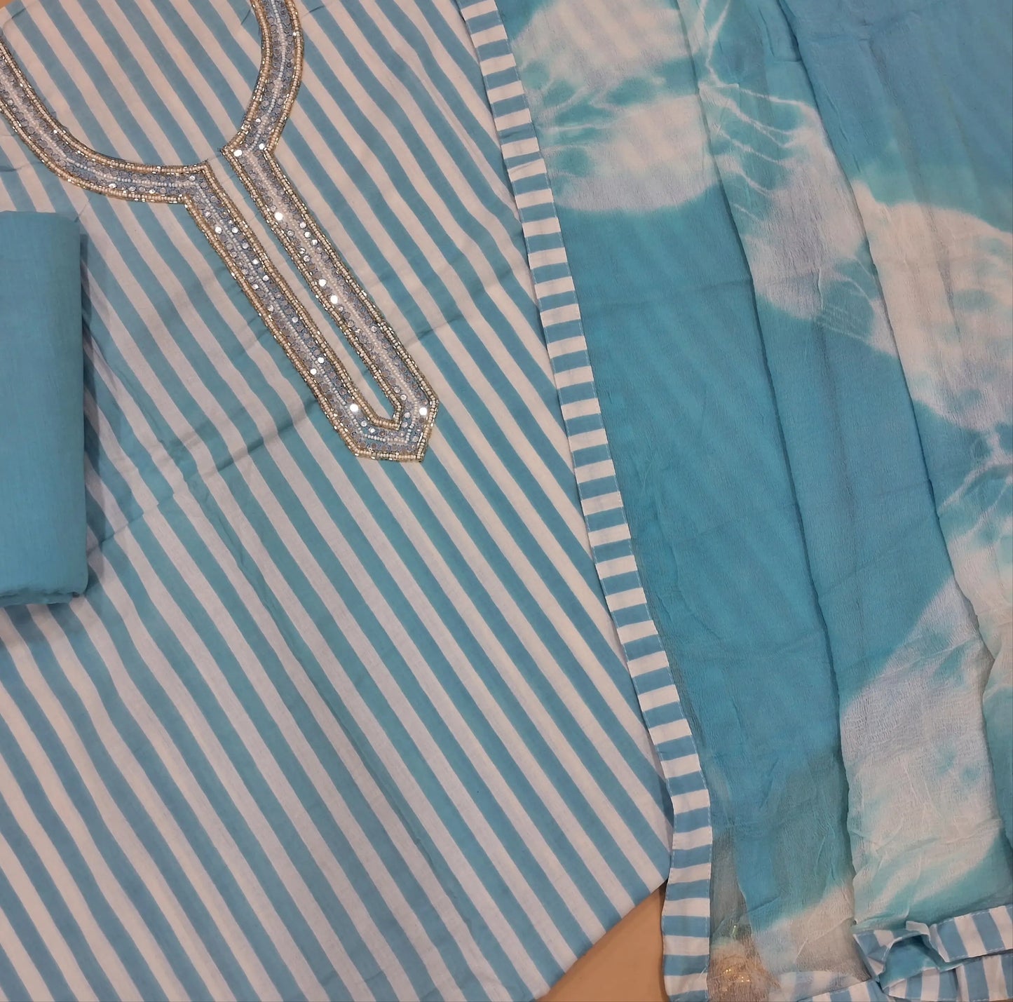 Pastel blue vertical printed pure soft cotton unstitched salwar material, sugar bead, faux mirror and cut work on yoke, (lining needed)drum dyed cotton fabric provided for lining, NO BOTTOM,shibori dyed pure chiffon dupatta. AP262203