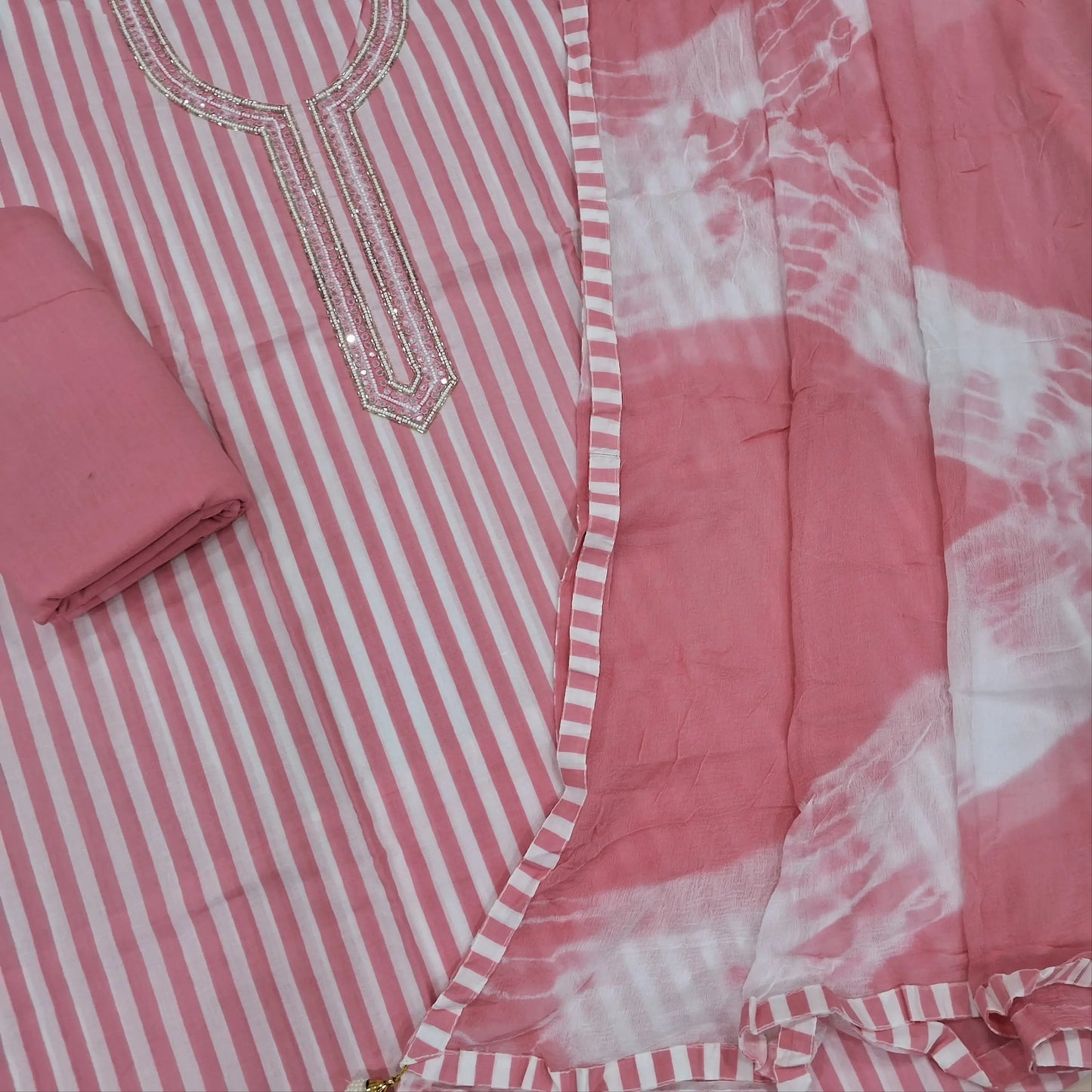 Pastel pink vertical printed pure soft cotton unstitched salwar material, sugar bead, faux mirror and cut work on yoke, (lining needed)drum dyed cotton fabric provided for lining, NO BOTTOM,shibori dyed pure chiffon dupatta. AP262202