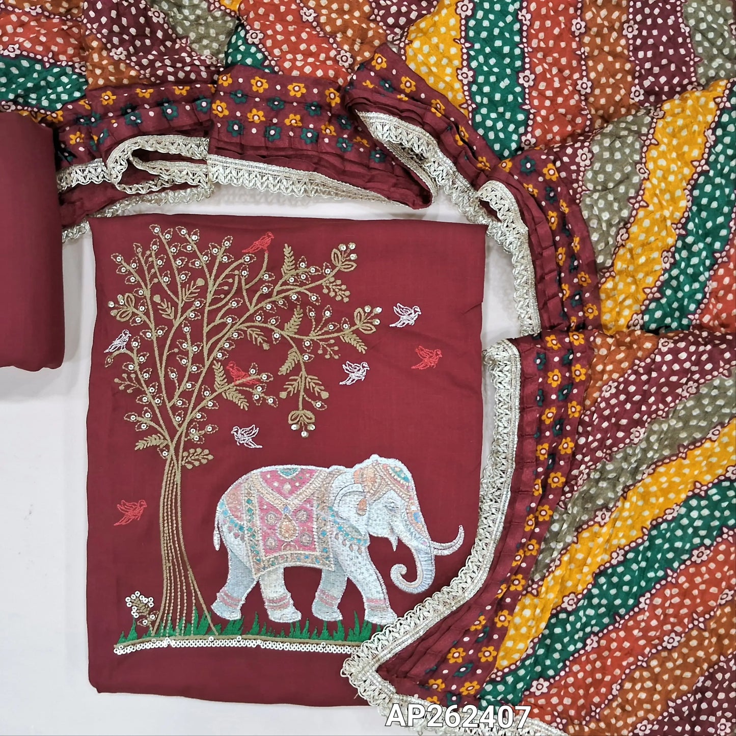Dark maroon liquid fabric unstitched salwar material( soft,Lining optional)zari and thread embroidery on yoke, ,matching liquid fabric bottom,multicolor crinkled fancy silk cotton dupatta with lace tapings. AP262407