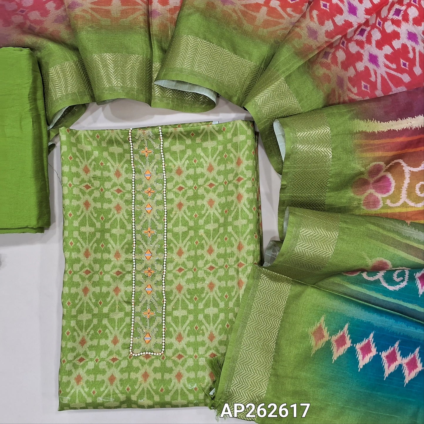 Green ikat printed fancy silk cotton unstitched salwar material, bead and real mirror work on yoke,buttas all over  (Lining Needed) Silkly bottom, multicoloured ikat  printed fancy silk dupatta. AP262617