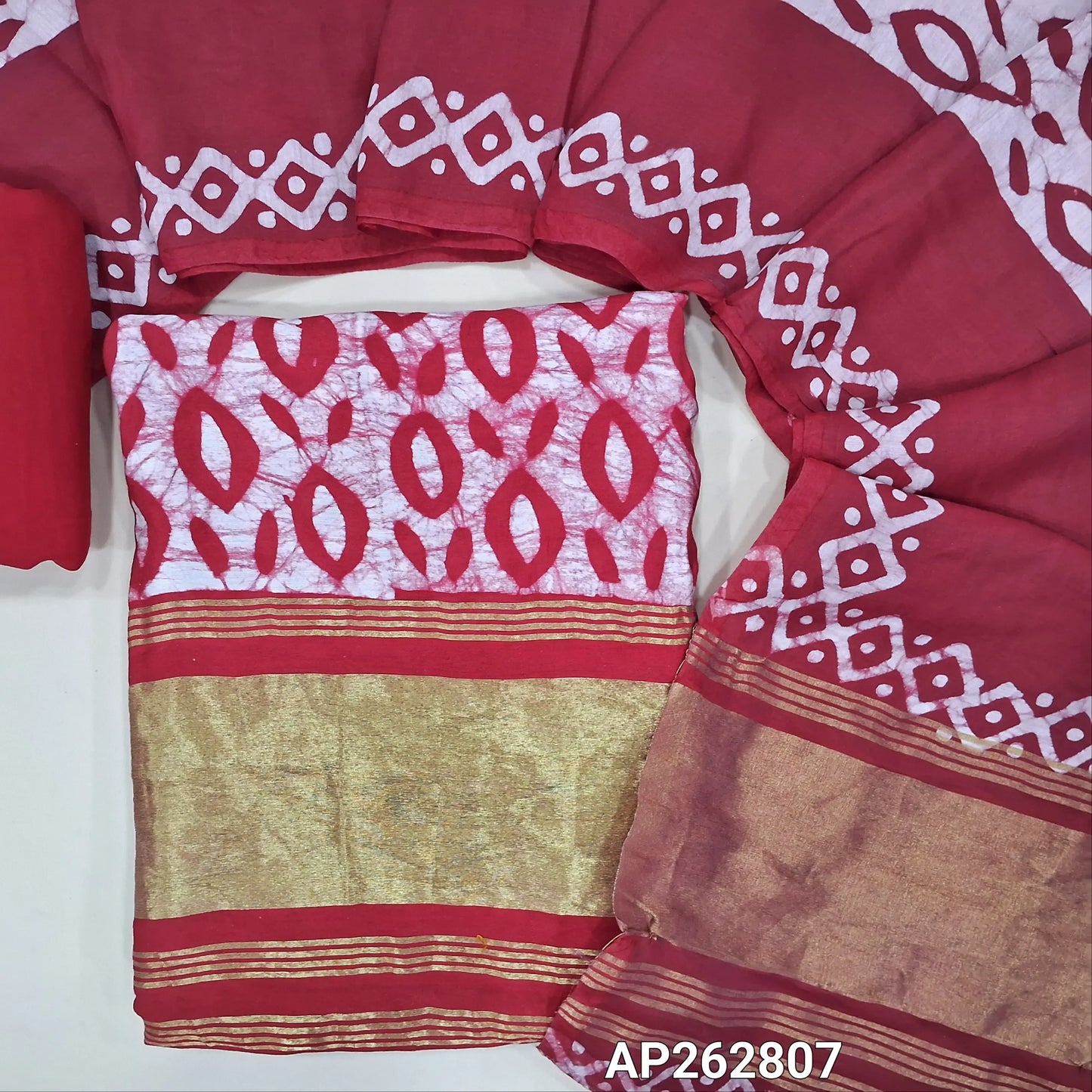 Reddish maroon original wax batik dyed soft modal silk cotton unstitched salwar material(lining needed)golden tissue on daman,santoom bottom,wax batik dyed soft modal silk cotton dupatta with gold tissue borders.AP262807