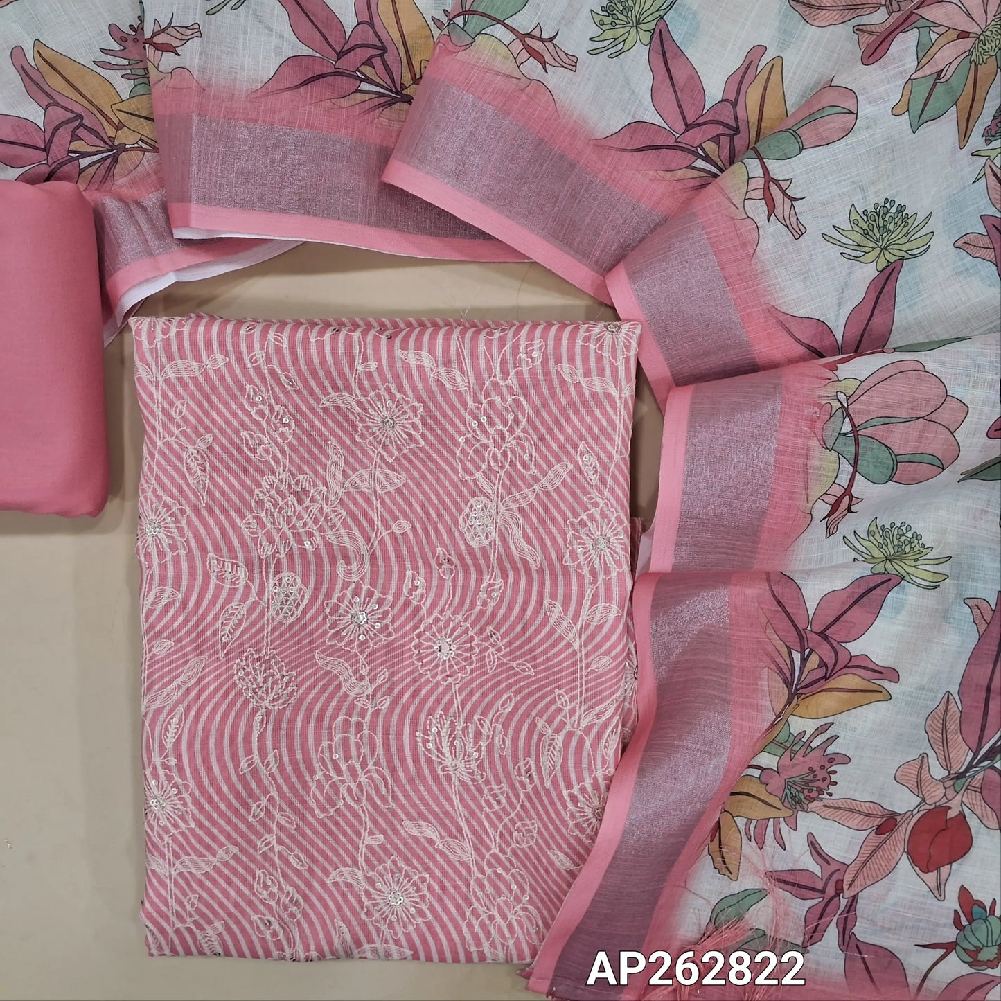Pastel pink abstract printed premium linen unstitched salwar material,rich floral thread embroidery (textured, lining needed) spun cotton bottom,colorful digital printed premium linen dupatta with silver tissue borders and fancy tassles. AP262822