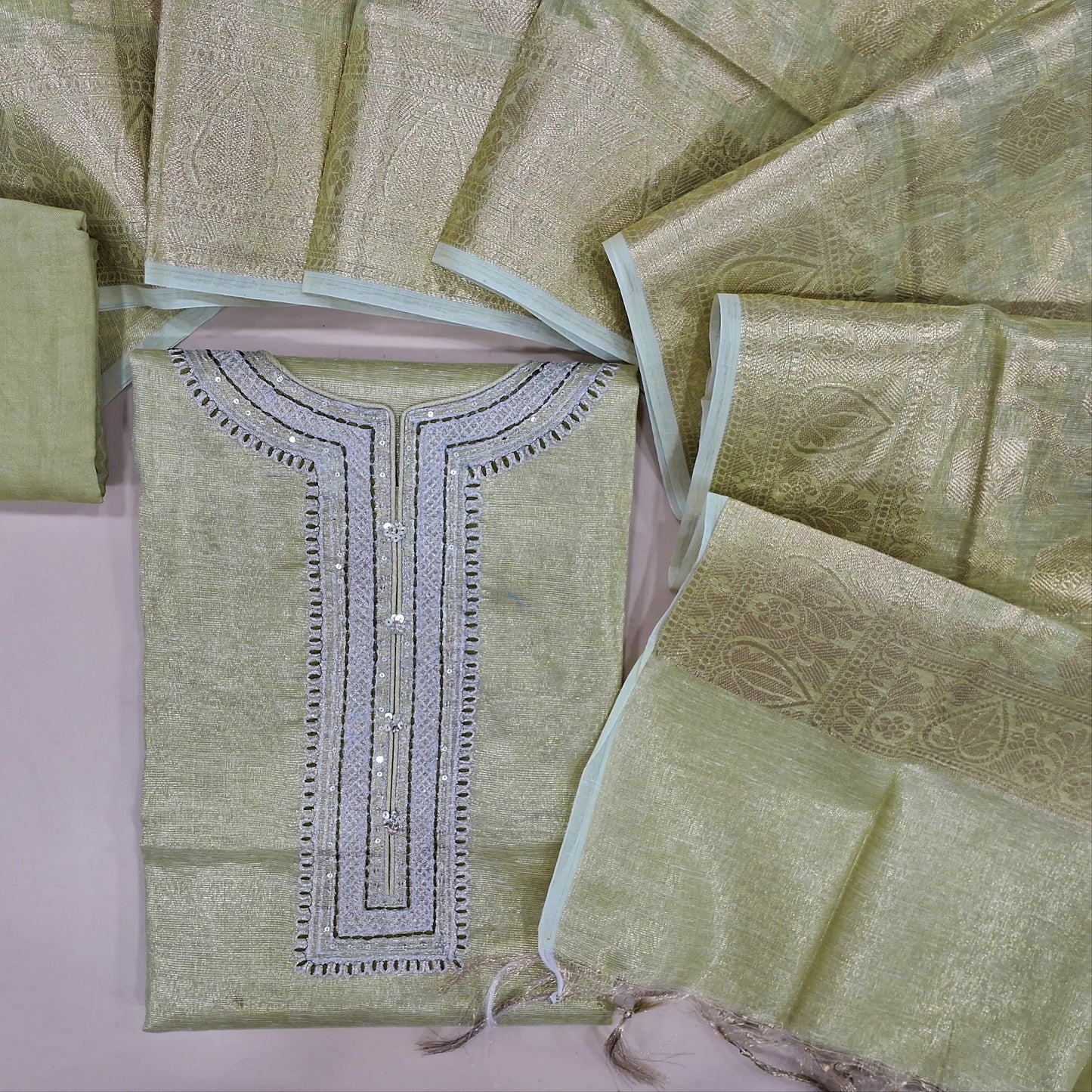 Pastel green with golden tint soft tissue silk cotton unstitched salwar material, zari& sequins work on yoke(thin fabric, lining needed)matching santoon bottom, banarasi zari woven tissue silk cotton dupatta with tassels. CODE OC242316