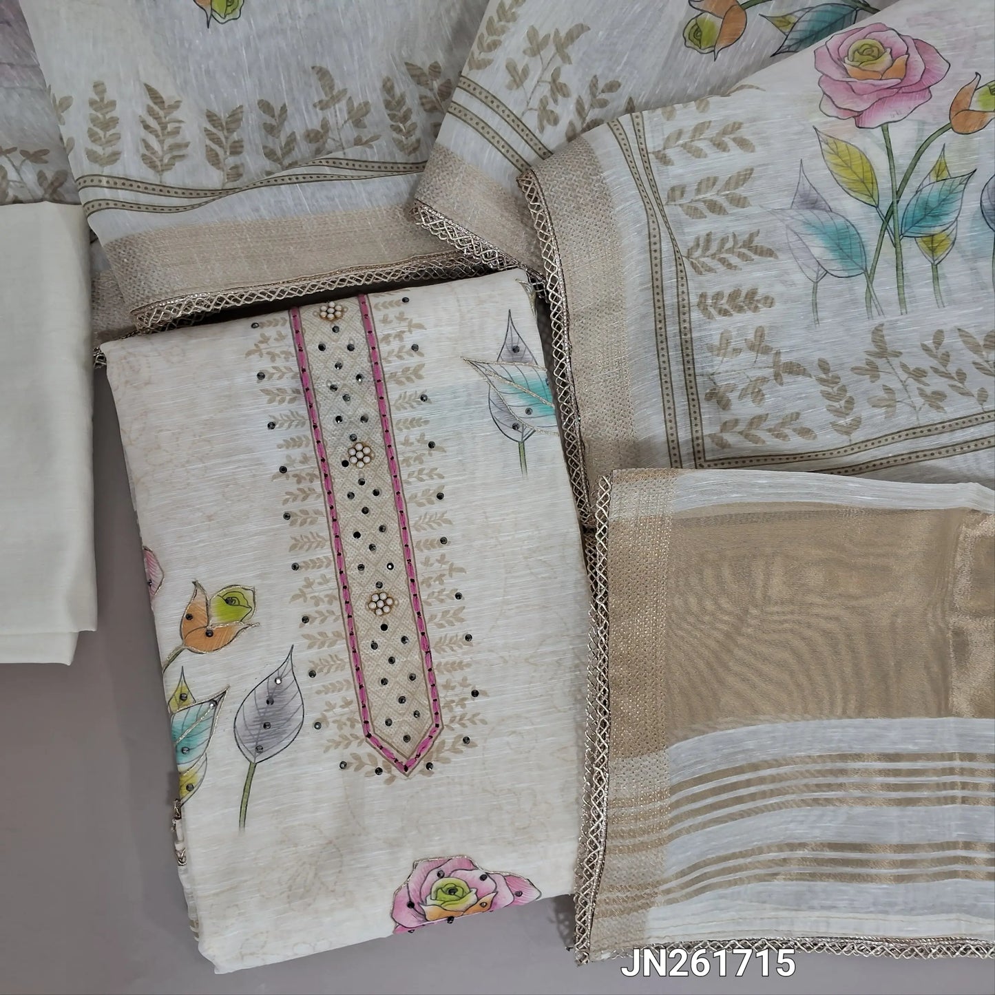 Designer off white floral printed linen unstitched salwar material,fancy buttons and sequins work on yoke & front, gold tissue border on daman( lining needed)matching cotton bottom,floral printed linen dupatta with fancy less tapping. JN261715