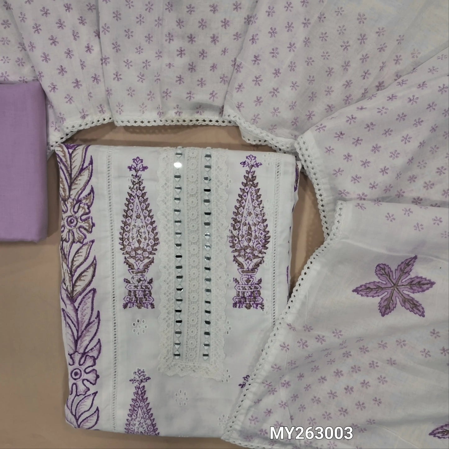 White hand block printed pure cotton unstitched salwar material, (lining needed) schiffli embroidery,real mirror & lace detailing on yoke,penal design, lavender cotton bottom,block printed full length soft mul cotton dupatta. MY263003