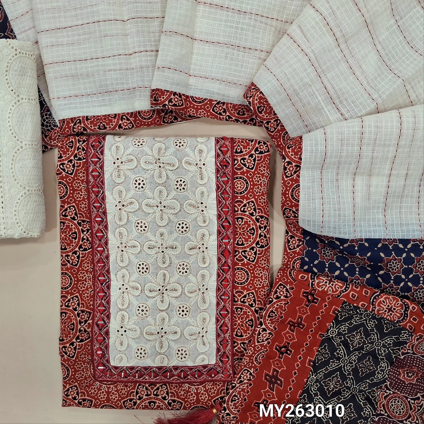 Reddish maroon ajrak hand block printed premium pure cotton unstitched salwar material(lining optional)embroidery & real mirror work on yoke, schiffli embroidery cotton bottom, kantha stitch detailing & applique work on kota dupatta with pallu. MY263010