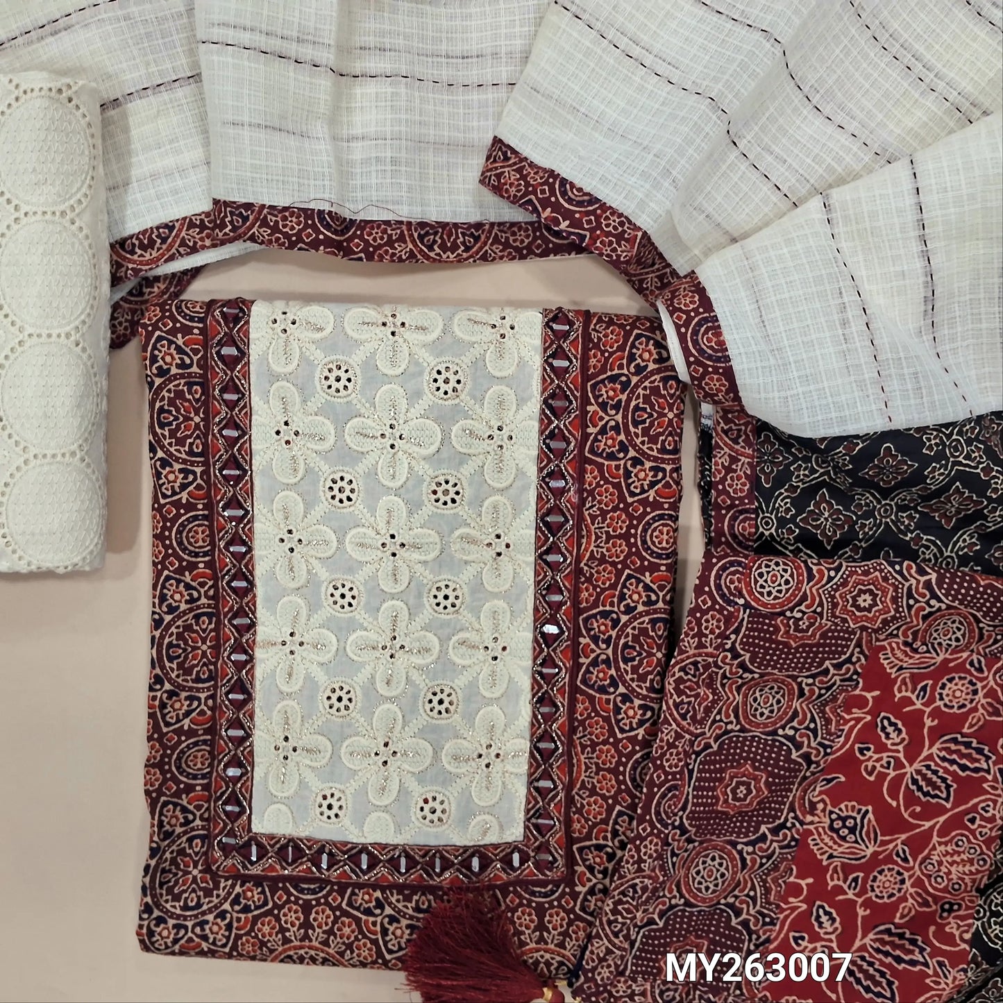 Dark maroon ajrak hand block printed premium pure cotton unstitched salwar material(lining optional)embroidery & real mirror work on yoke, schiffli embroidery cotton bottom, kantha stitch detailing & applique work on kota dupatta with pallu. MY263007