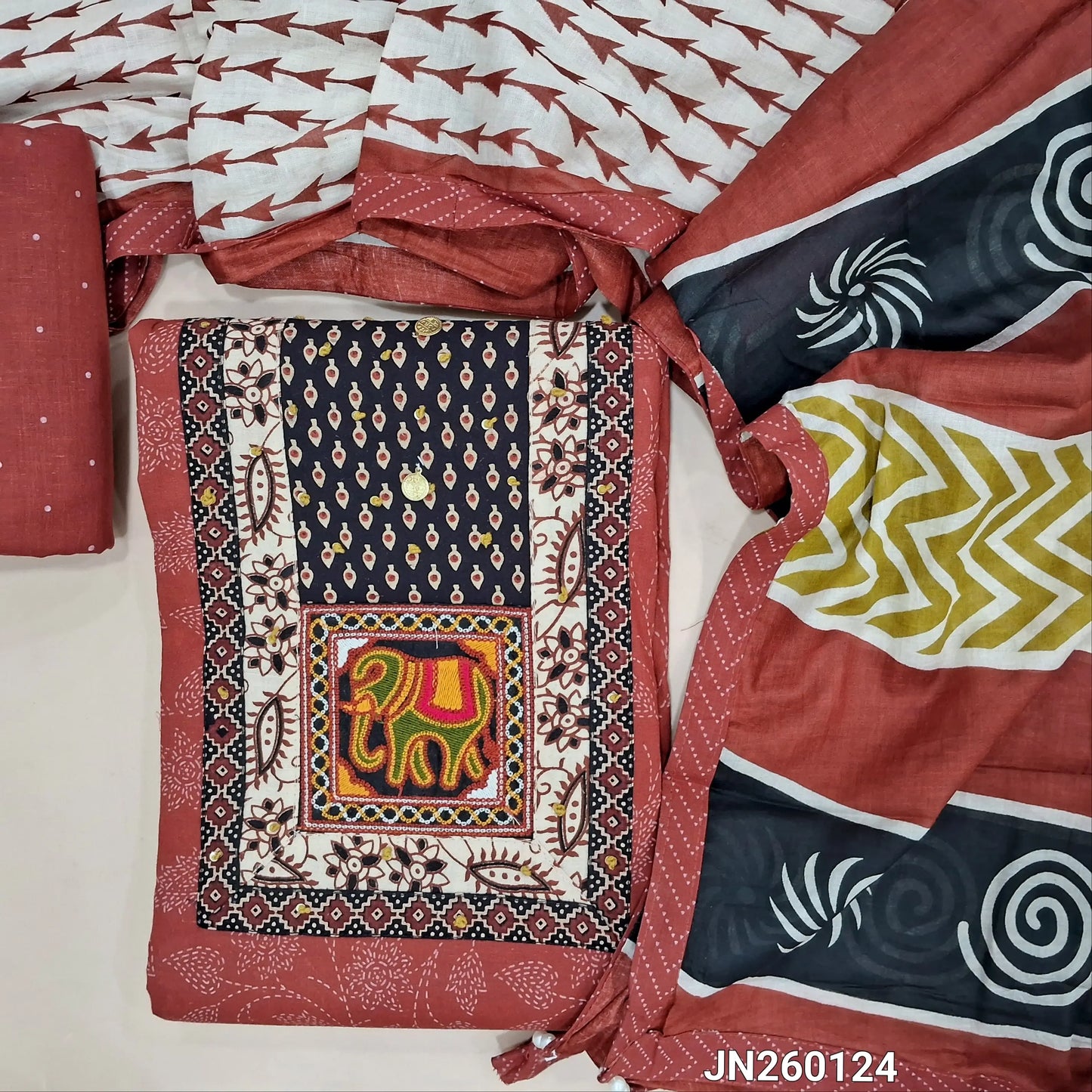 Reddish maroon printed pure cotton unstitched salwar material, ajrak yoke patch with hand embroidery work(lining optional)printed cotton bottom,printed soft mul cotton dupatta. JN260124
