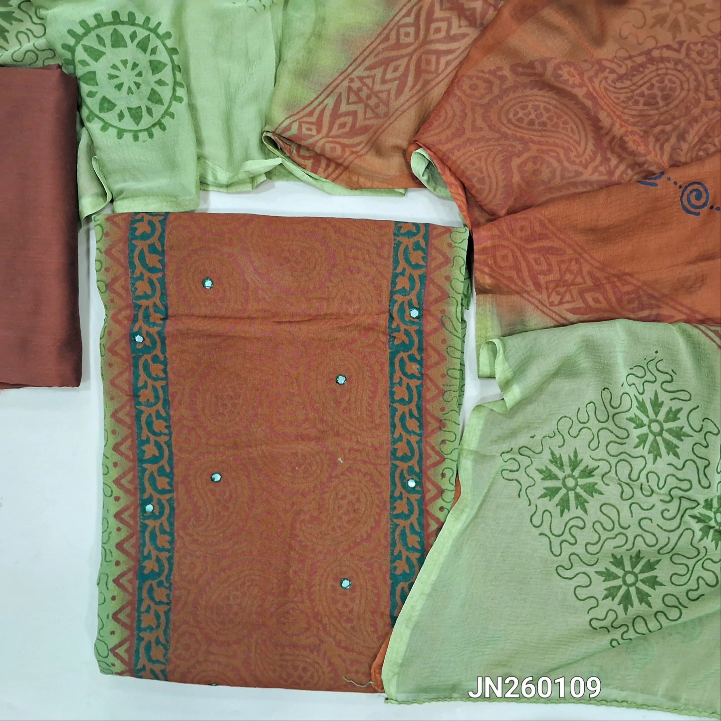 Brown & pastel green block printed semi georgette unstitched salwar material,(lining needed)panel design, faux mirror work on front, brown silk cotton bottom, block printed dual shaded fancy chiffon dupatta.(TAPING NEEDED) JN260109