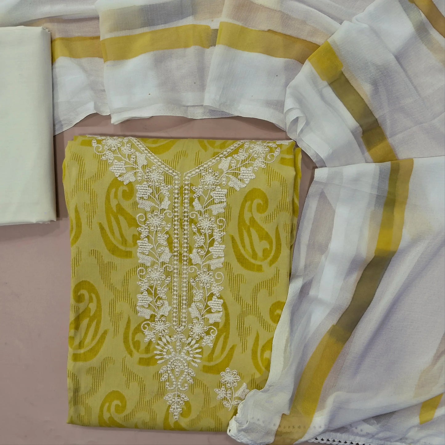Yellowish green jakard cotton unstitched salwar material,embroidery work on yoke, (lining optional)off white cotton bottom,brush paint on chiffon dupatta. MY263110