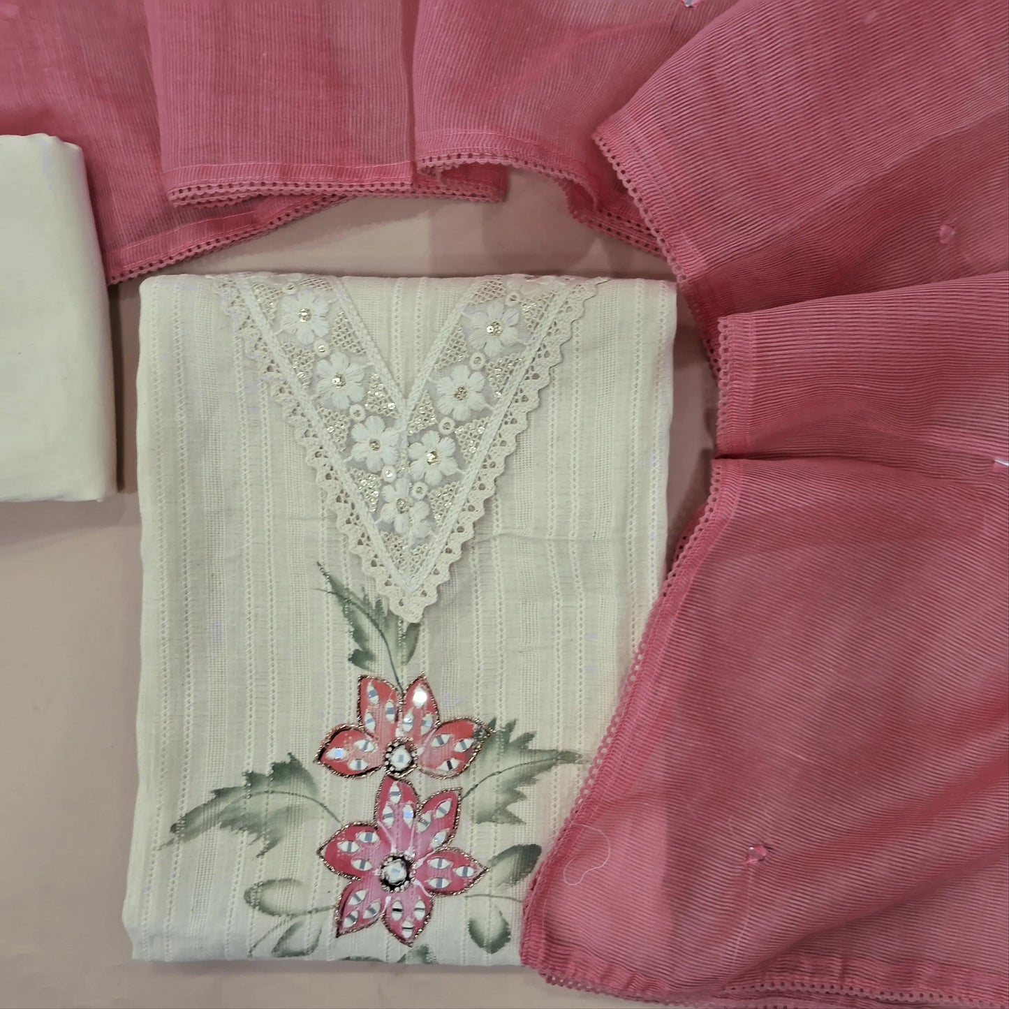 Off white base pure cotton unstitched salwar material,V neck with embroidery and lace work,brush paint and real mirror on front, (lining needed)cotton bottom, real mirror work on supernet dupatta. MY263107