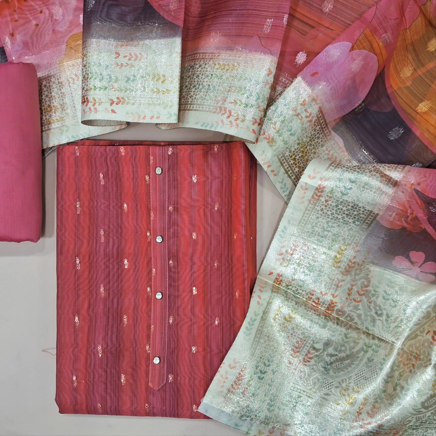 Pink fancy organza unstitched salwar material,zari buttas all over(thin, lining needed)silk cotton bottom,digital printed and benarasi woven on fancy organza dupatta with pallu. MY263105