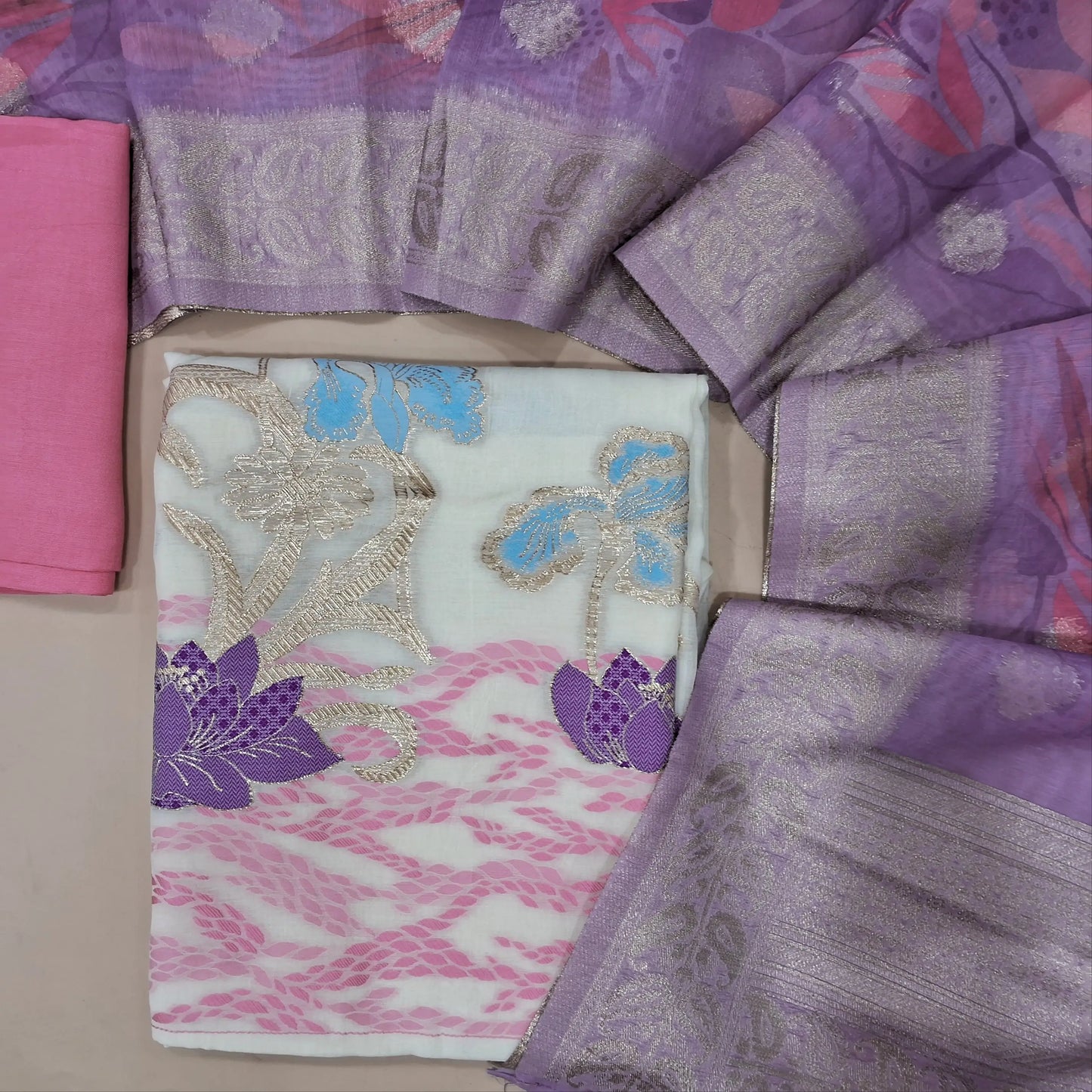 Off white base mul chanderi unstitched salwar material , rich weaving on daman,(thin, lining needed)pink santoon bottom, digital printed and zari buttas on soft silk cotton dupatta with pallu. MY263113