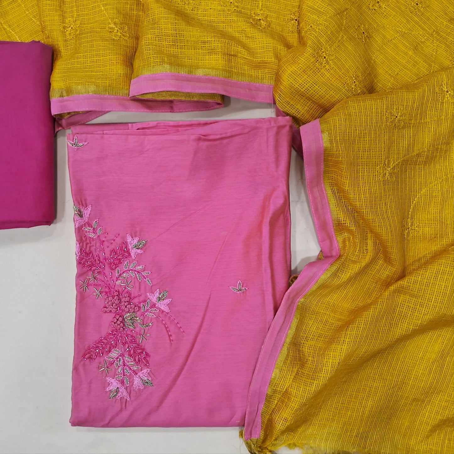 Pink fancy silk cotton unstitched salwar material, bead work on yoke (Lining Needed) embroidery and bead work on front, pink bottom, fancy kota contrast dupatta with embroidery. MY263117