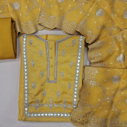 Designer yellow dola silk unstitched salwar material, rich gota work on yoke (Lining Needed) matching bottom, benarasi zari woven dola silk dupatta. MY263118