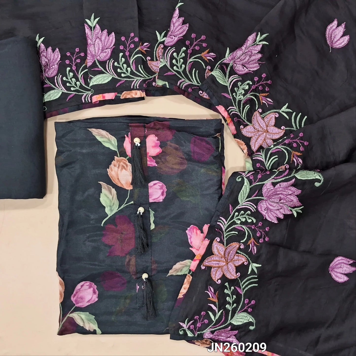 Designer black pure soft malai silk unstitched salwar material,tasseles work on yoke( shiny,lining needed) floral printed all over,matching santoon bottom, rich embroidery work on soft silk cotton dupatta. JN260209