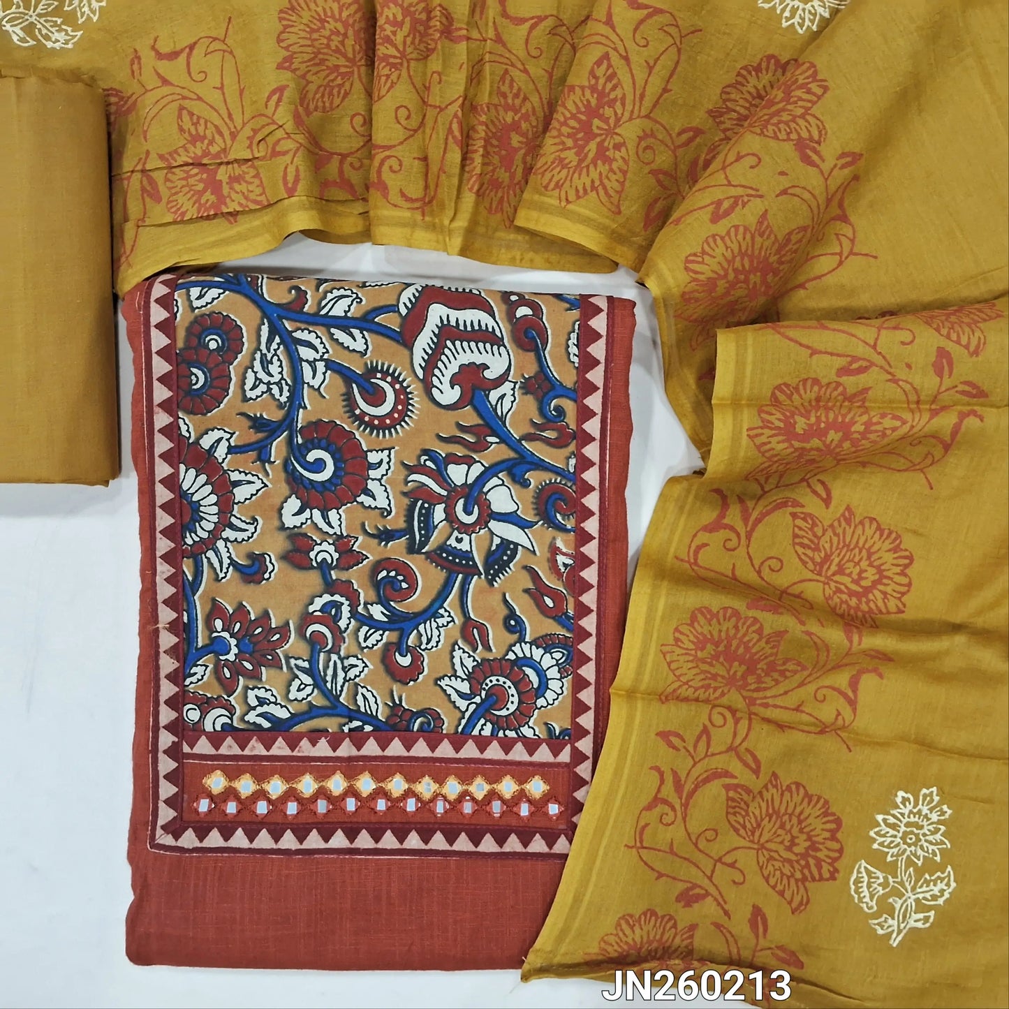 Brick red pure cotton unstitched salwar material,hand block printed kalamkari yoke patch with faux mirror work,(lining needed)mehandhi yellow cotton bottom,hand block printed mul cotton dupatta. JN260213