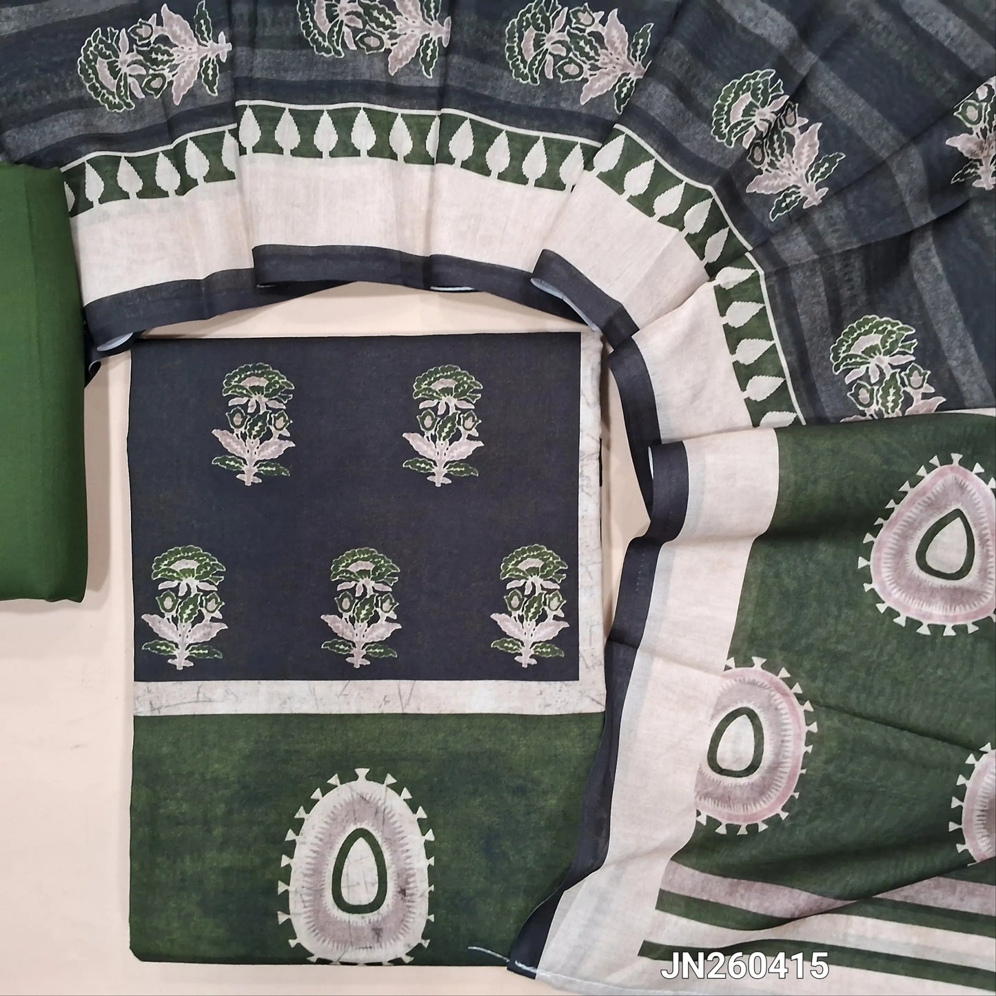 Black digital printed silk cotton unstitched salwar material(lining optional)panel design on front,ajrak prints all over, leafy green cotton bottom, digital printed soft silk cotton dupatta. JN260415