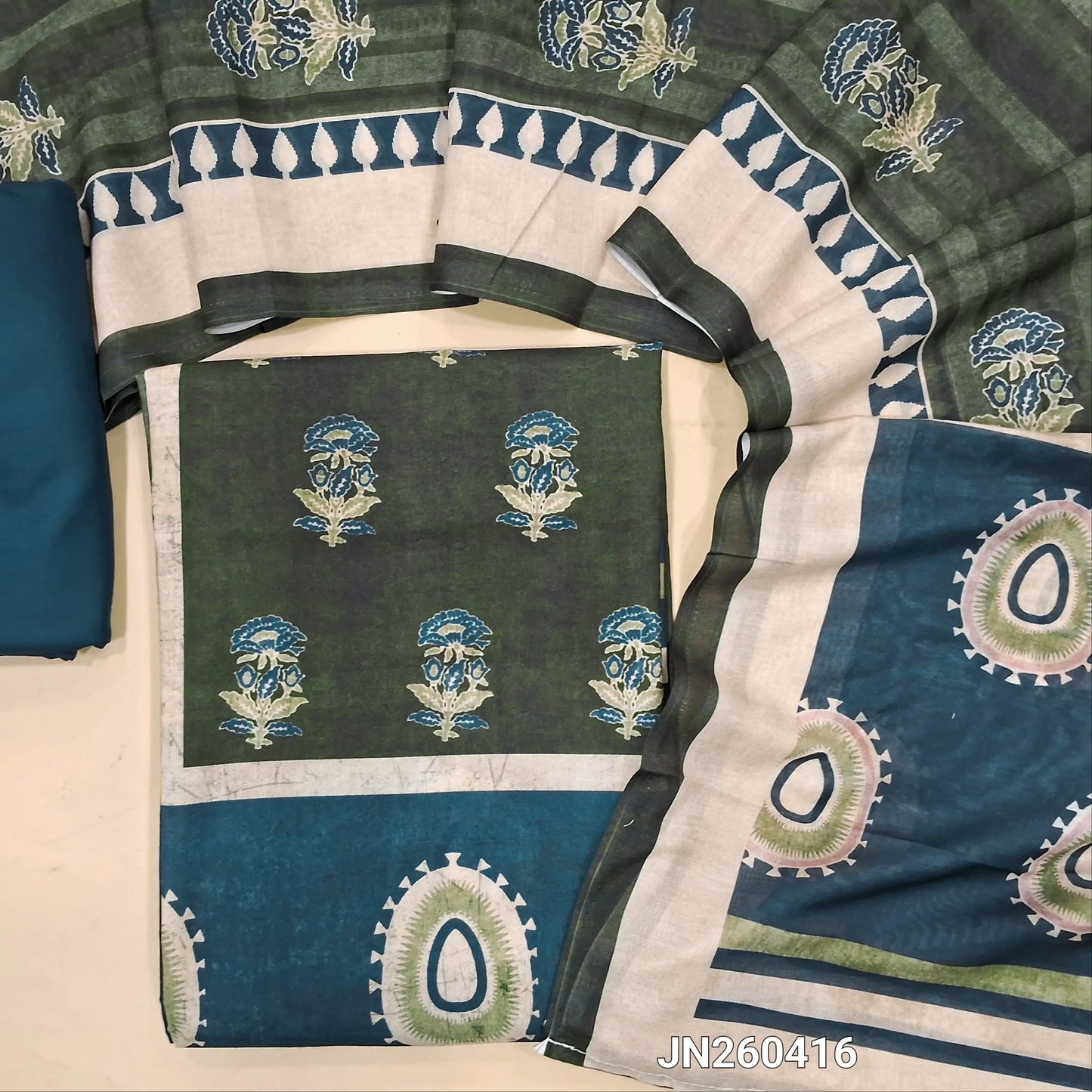 green digital printed silk cotton unstitched salwar material(lining optional)panel design on front,ajrak prints all over, teal blue cotton bottom, digital printed soft silk cotton dupatta. JN260416