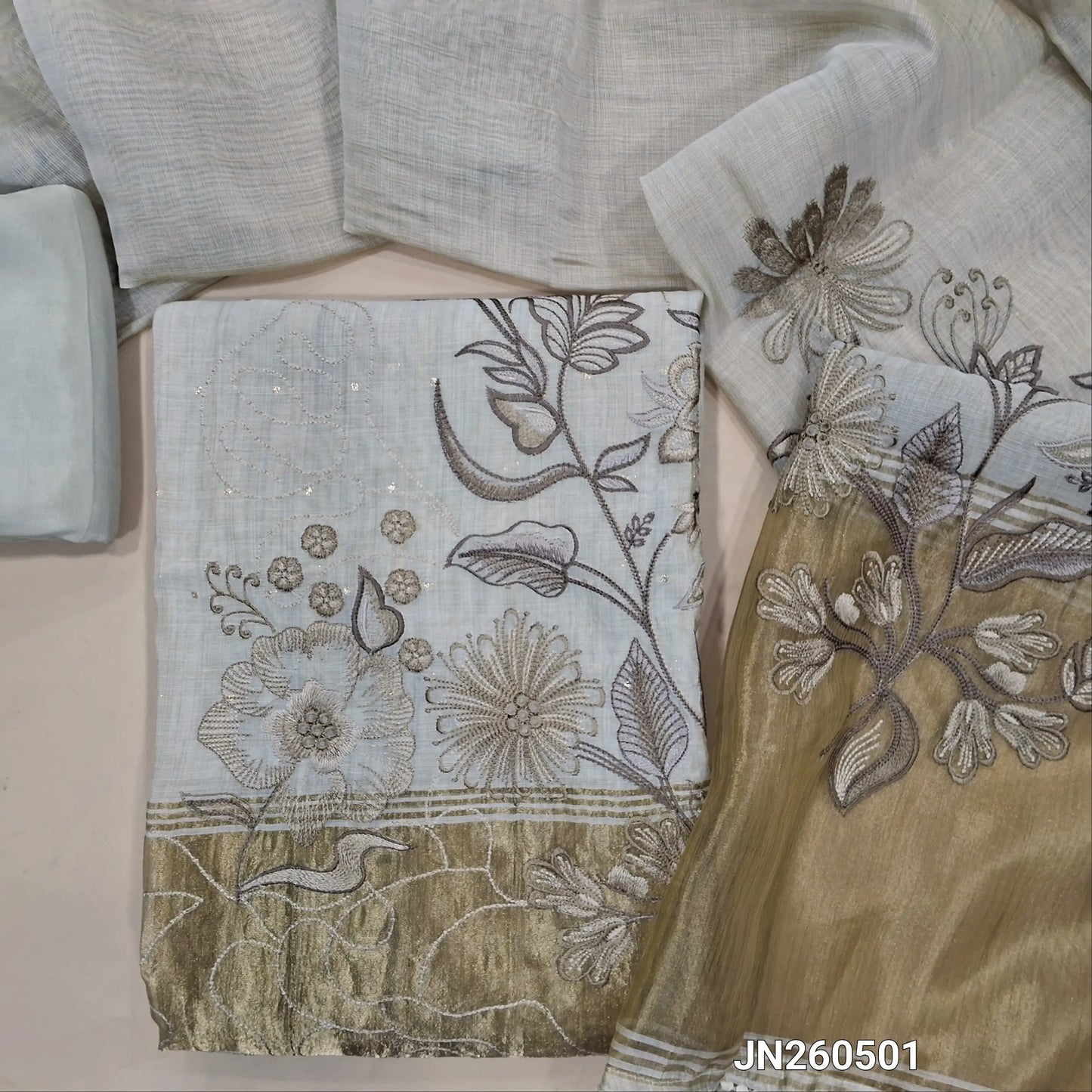 Rich beige premium silk cotton unstitched salwar material,zari buttas all over,silver& anti gold zari embroidery,tissue work on daman(lining needed)matching santoon bottom,soft silk cotton dupatta with silver gold tissue with zari work pallu. JN260501