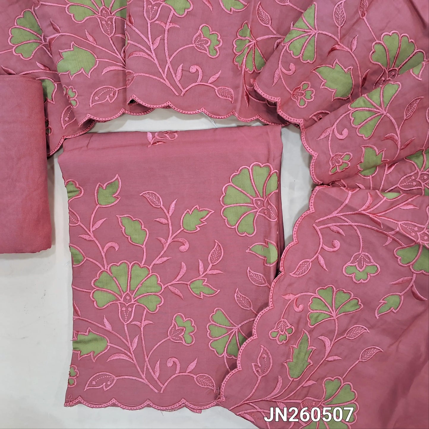 Pink soft silk cotton unstitched salwar material (lining needed) embroidery work on front, self embroidery and applique patch work on daman ,matching santoon bottom, rich applique &self embroidery work on silk cotton dupatta. JN260507