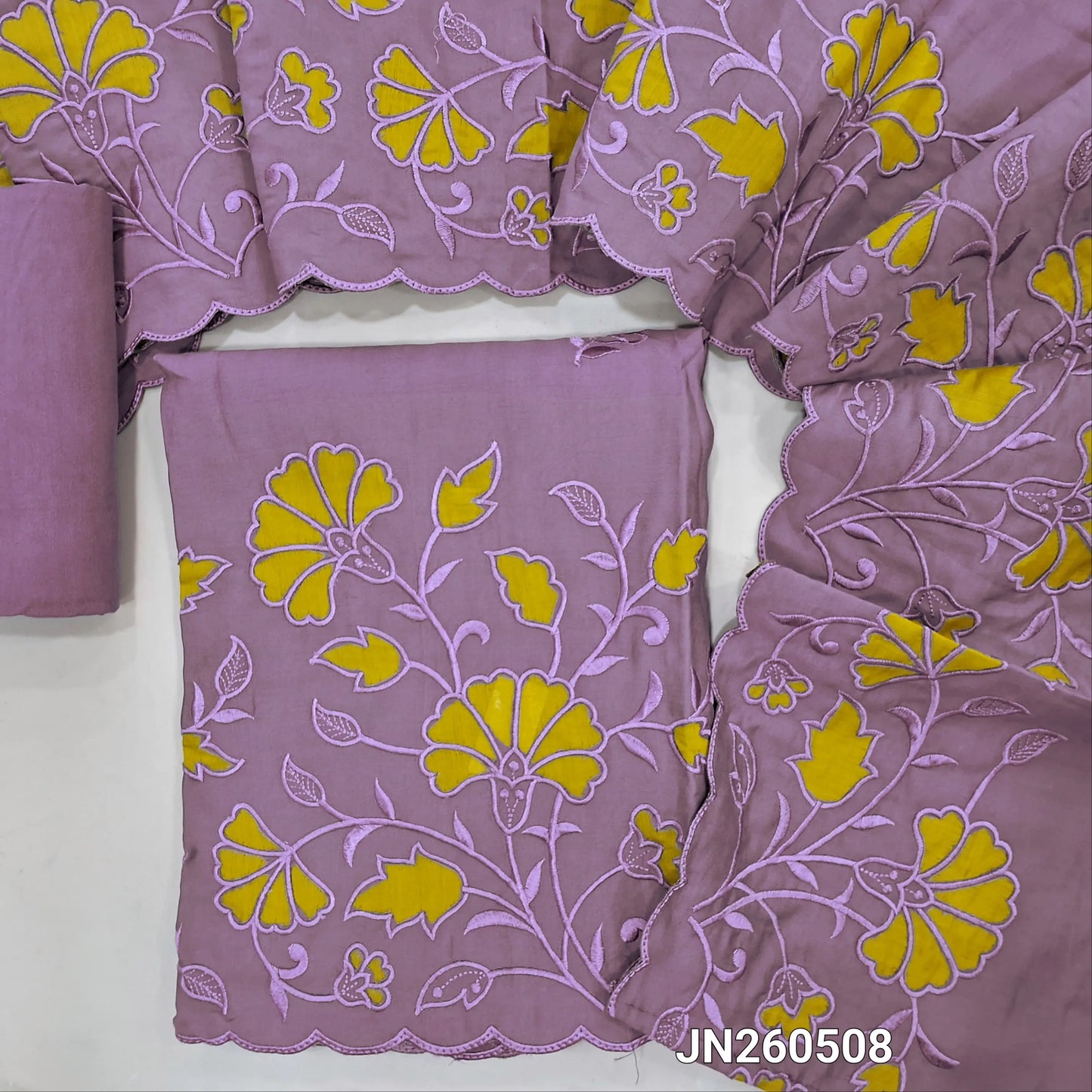 Light purple shade soft silk cotton unstitched salwar material (lining needed) embroidery work on front, self embroidery and applique patch work on daman ,matching santoon bottom, rich applique &self embroidery work on silk cotton dupatta. JN260508