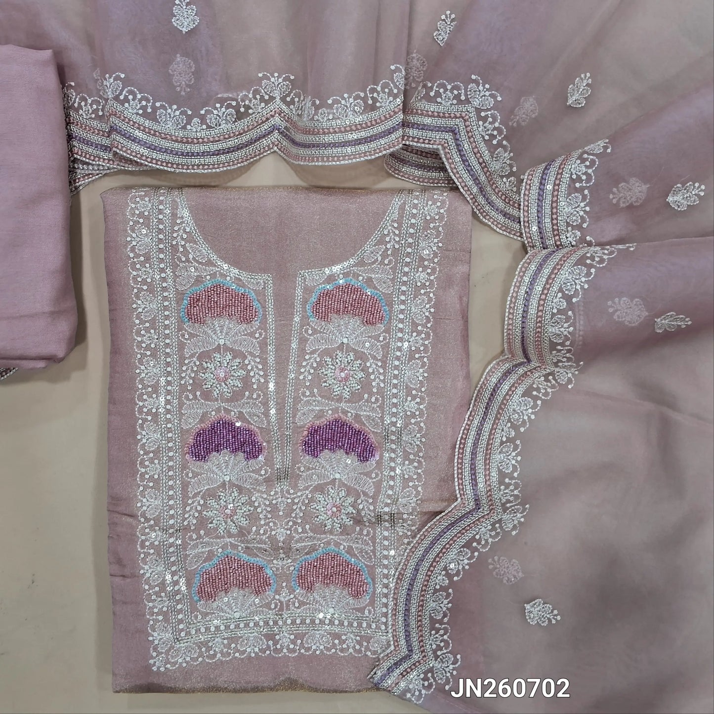 Pastel pink & silver tint organza silk unstitched salwar material, bead & sequins work on yoke(lining needed)matching santoon bottom, embroidered organza dupatta with scallop edges. JN260702