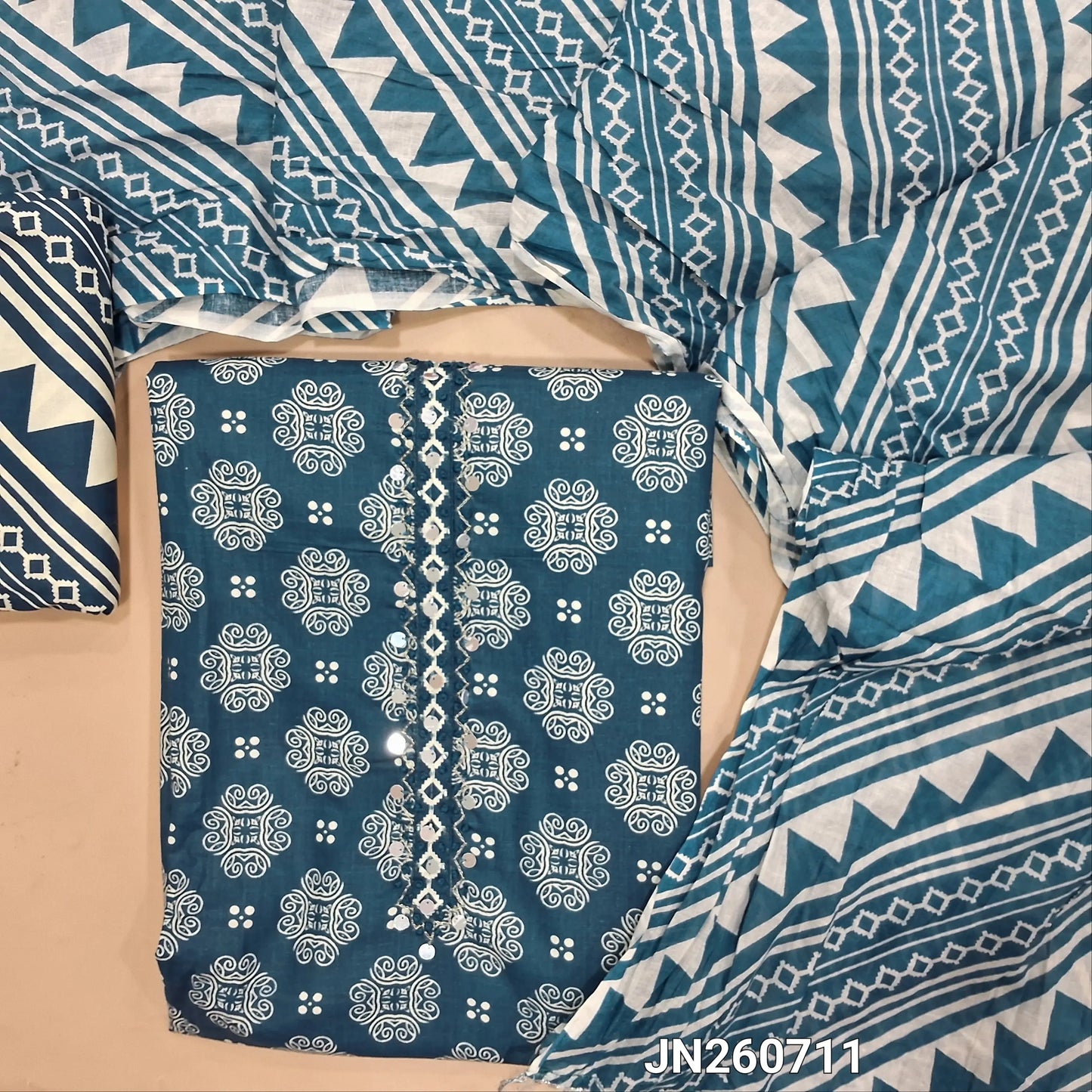 Blue pure cotton unstitched salwar material, sequins work on yoke, floral printed all over,(lining optional) printed cotton bottom, printed pure mul cotton full length dupatta. JN260711