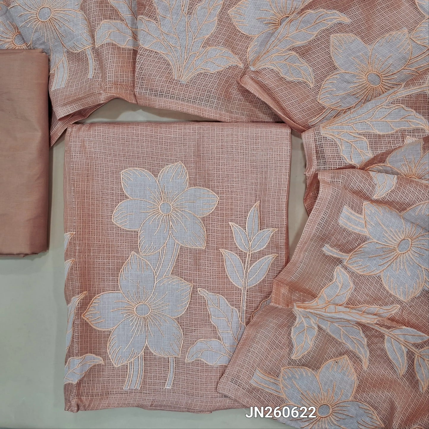 Light peachish pink premium kota unstitched salwar material,thread embroidery,applique and patch work on daman(Lining Needed) matching silky fabric for both bottom and lining,applique work and floral embroidery on kota dupatta. JN260622