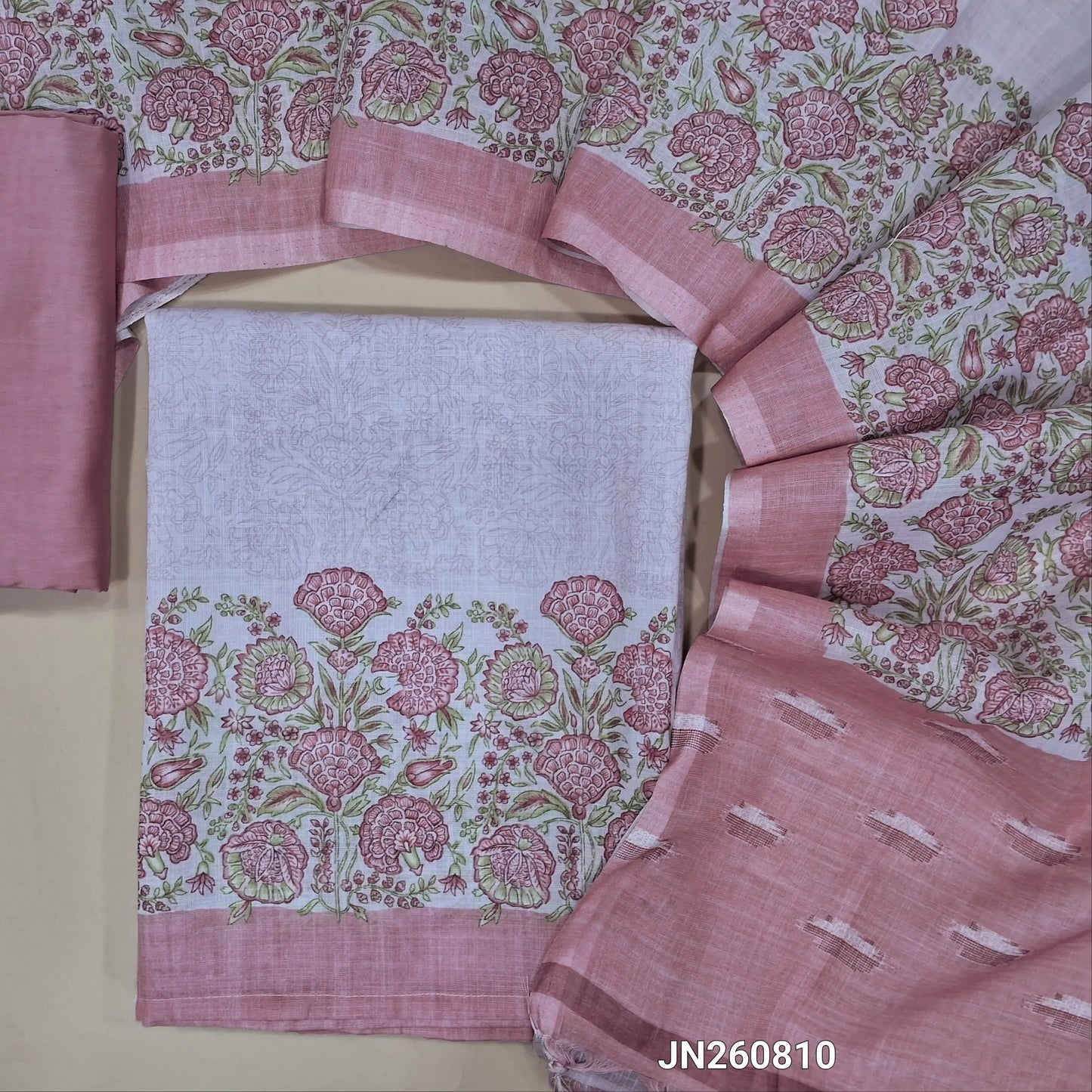 Pale pink semi linen unstitched salwar material, printed daman border,(thin fabric, lining needed)pastel pink silky bottom,printed full length semi linen dupatta with pallu. JN260810