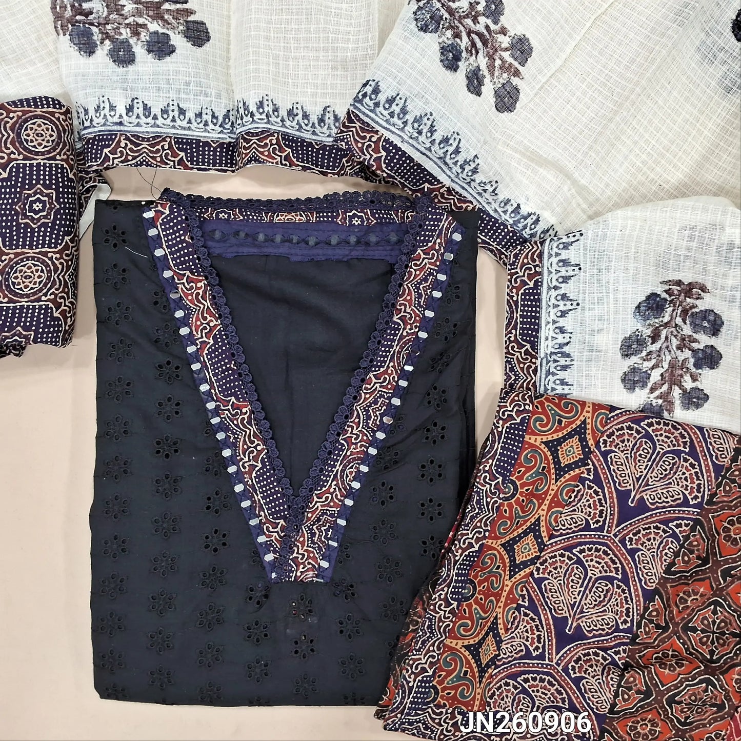 Black schiffli embroidery dobby cotton unstitched salwar material,collar neck with ajrak &real mirror work on yoke,(lining needed)blue printed cotton bottom, block printed kota dupatta with applique work on pallu. JN260906