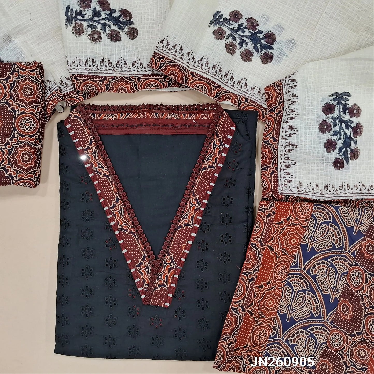 Black schiffli embroidery dobby cotton unstitched salwar material,collar neck with ajrak &real mirror work on yoke,(lining needed)maroon printed cotton bottom, block printed kota dupatta with applique work on pallu. JN260905