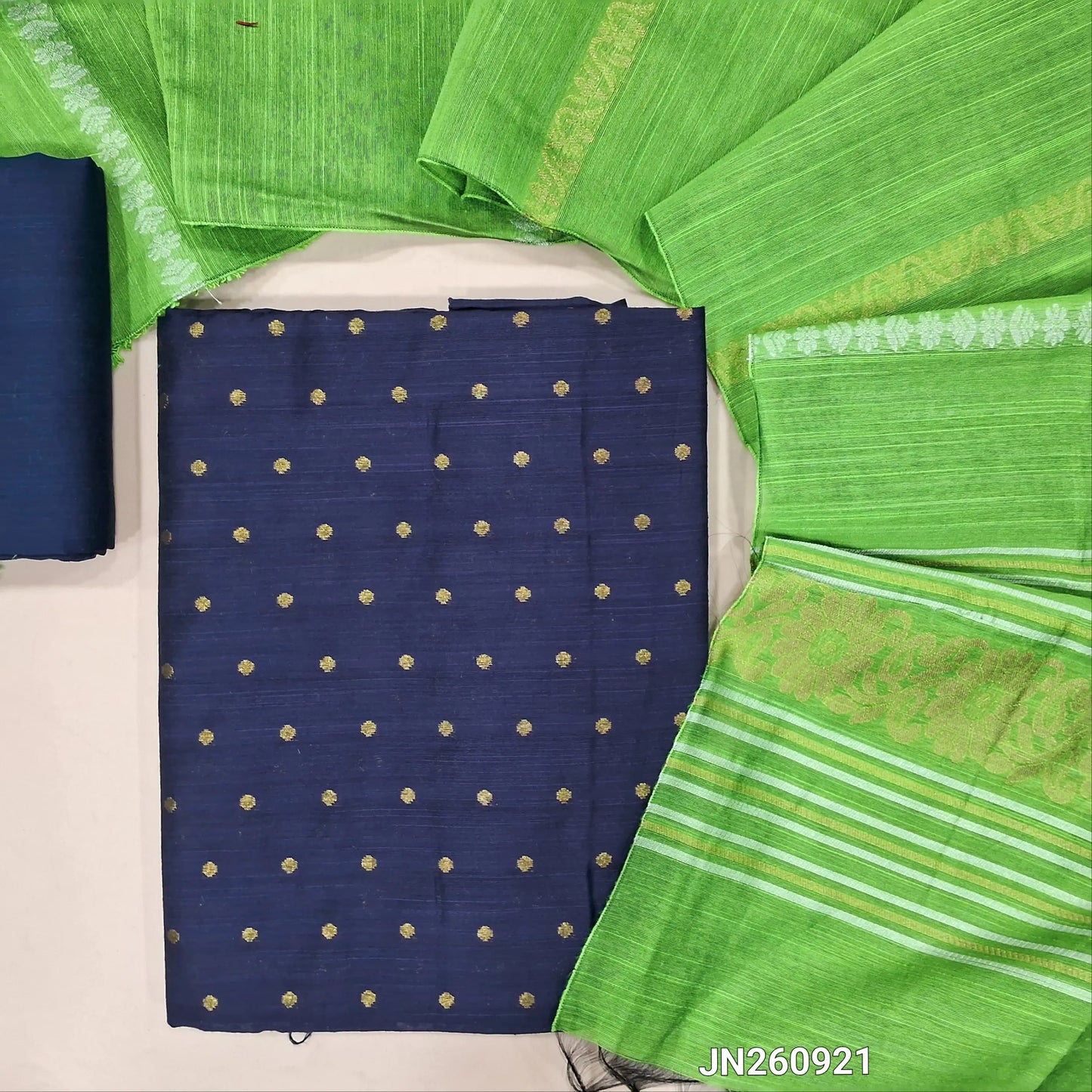 Dark blue slub silk cotton unstitched salwar material, gold zari weaving all over(lining needed)matching silk cotton bottom,silver and gold zari weaving on slub silk cotton dupatta with pallu.(TAPING NEEDED) JN260921