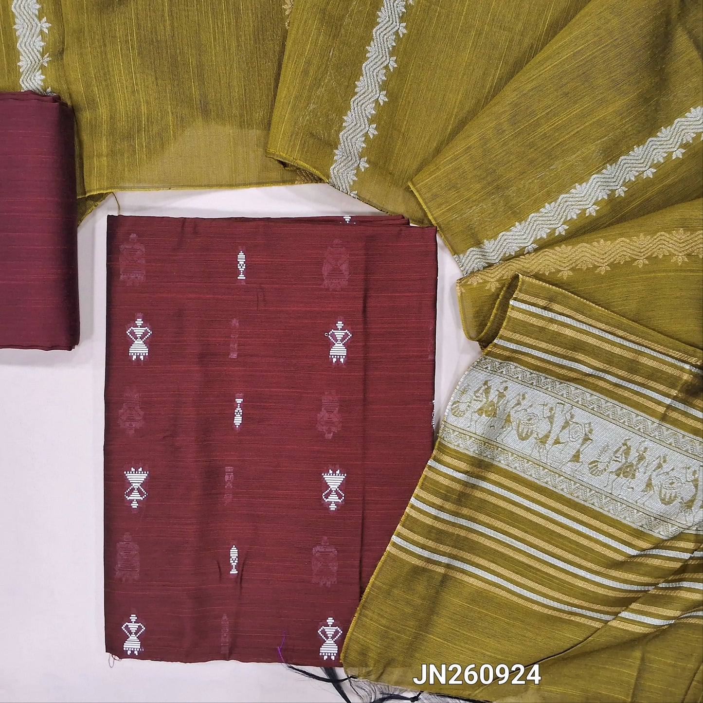 Maroon slub silk cotton unstitched salwar material,warli weaving all over(lining needed)matching silk cotton bottom,silver and gold zari weaving on slub silk cotton dupatta with pallu.(TAPING NEEDED) JN260924