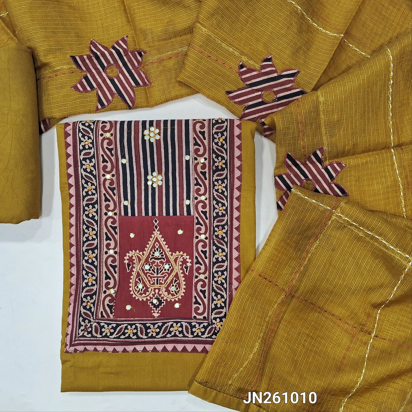 Mehandhi yellow premium dabu cotton unstitched salwar material,hand block prints & ajrak yoke patch with faux mirror work on yoke(lining optional)matching spun cotton bottom, floral applique work on kantha stitch detailing & kota dupatta. JN261010