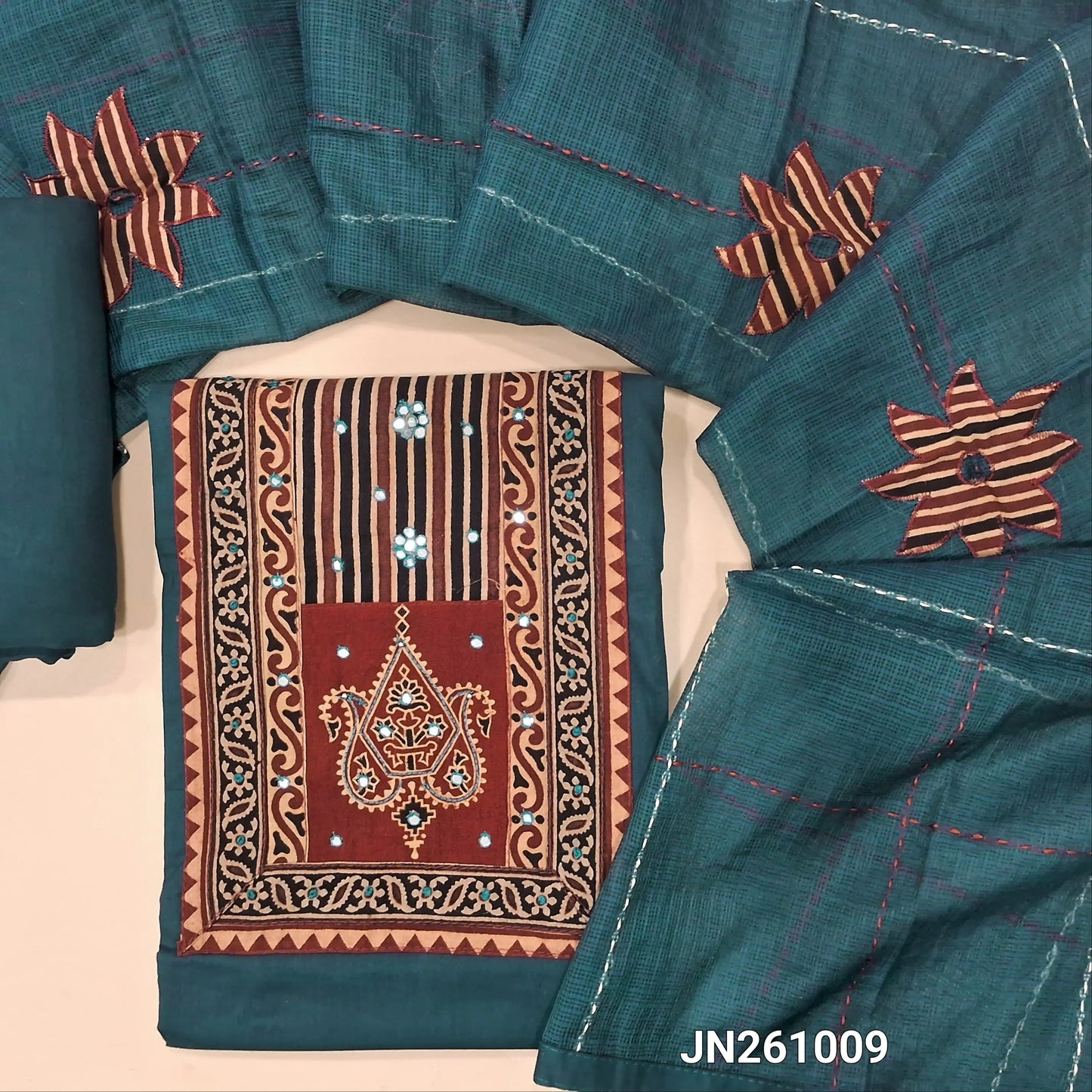 Dark teal blue premium dabu cotton unstitched salwar material,hand block prints & ajrak yoke patch with faux mirror work on yoke(lining optional)matching spun cotton bottom, floral applique work on kantha stitch detailing & kota dupatta. JN261009