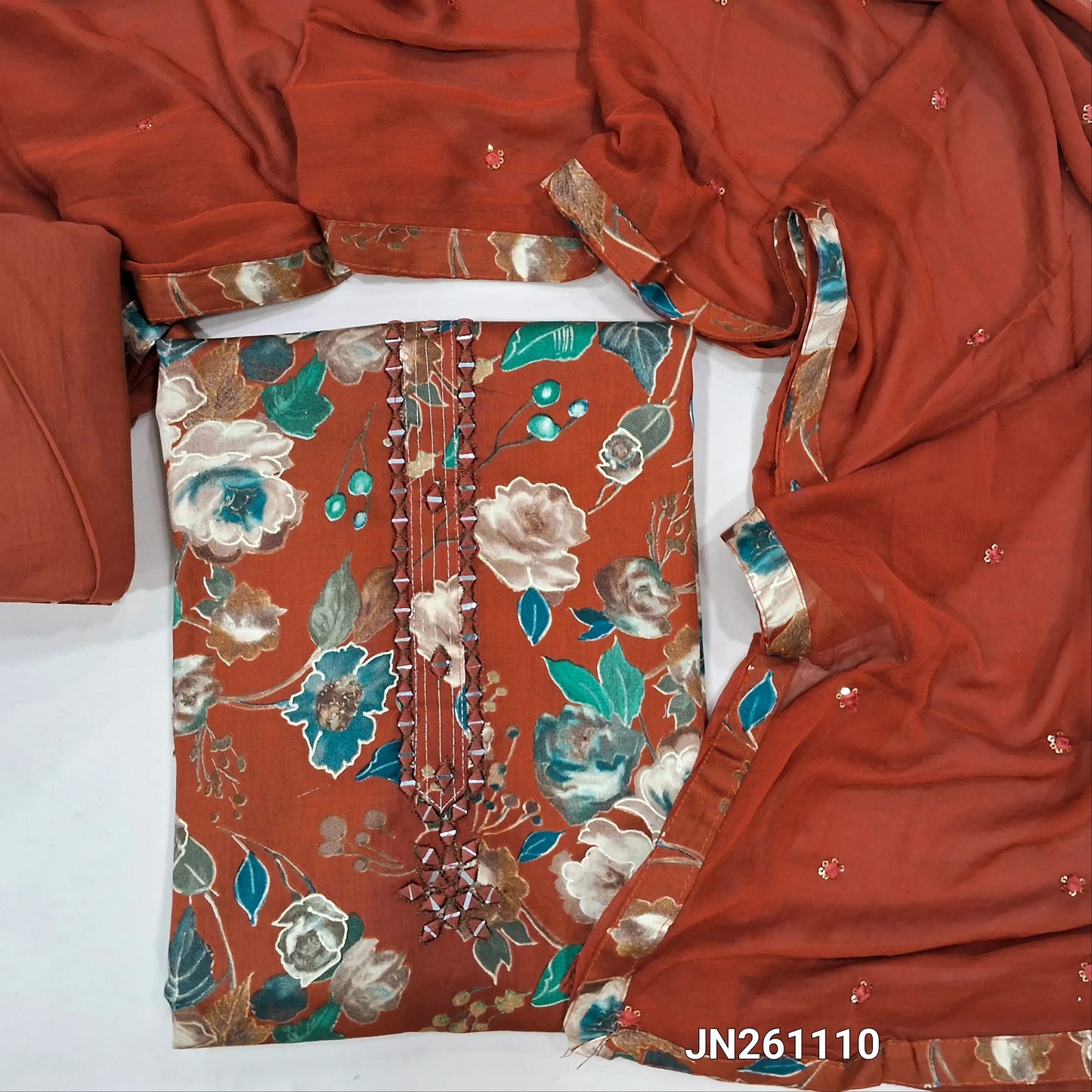Brick red premium floral printed satin cotton unstitched salwar material, real mirror work on yoke( textured,lining optional)matching cotton bottom,thread & sequins work on fancy chiffon dupatta. JN261110