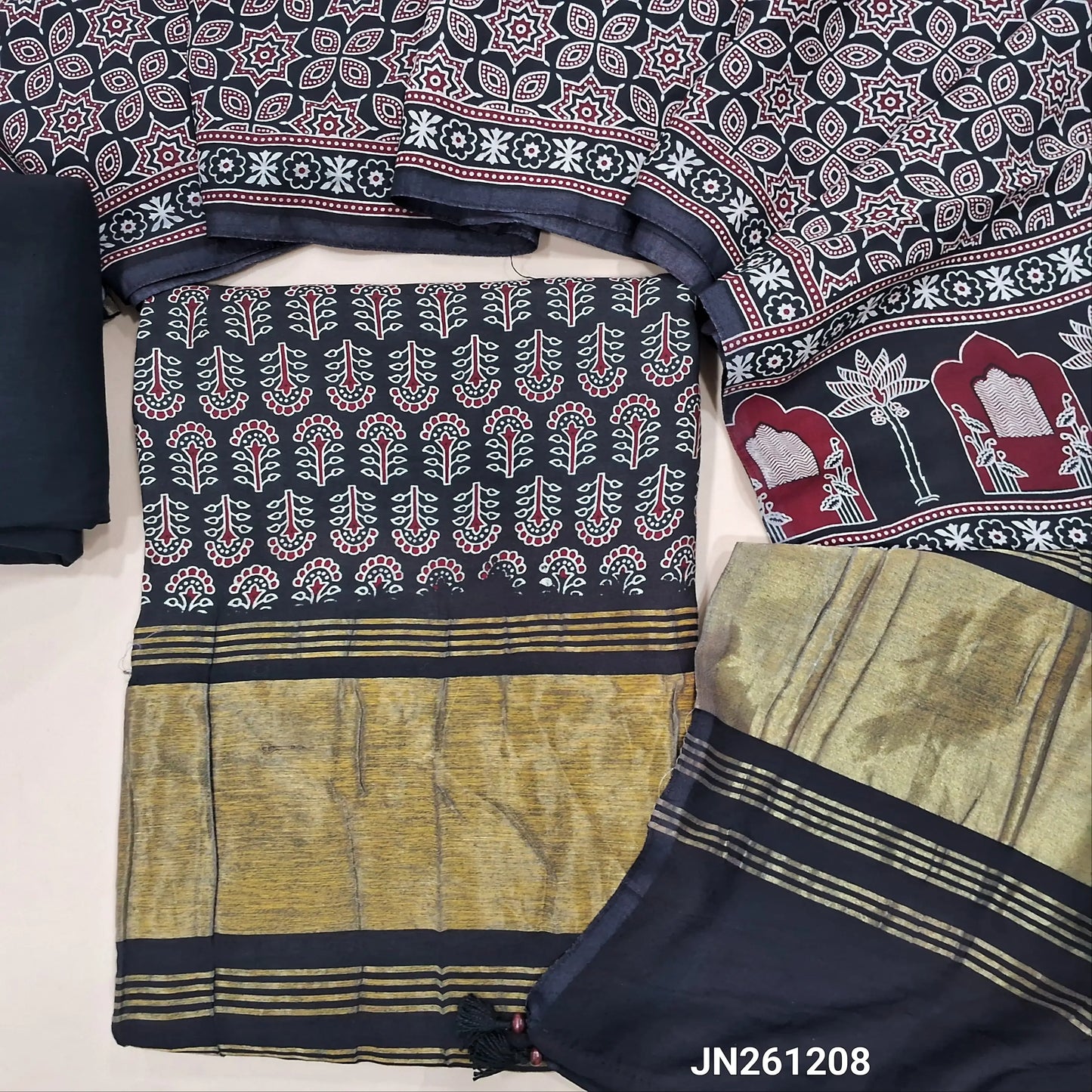Black ajrak printed taspa silk unstitched salwar material(lining needed) gold tissue borders on daman, hand block prints all over,matching cotton bottom,ajrak printed taspa silk dupatta with tissue pallu (TAPING NEEDED) JN261208
