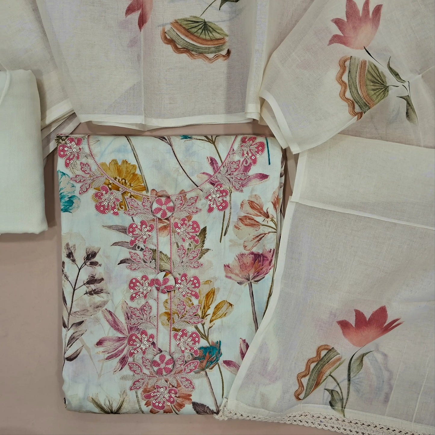 Off white base floral printed satin cotton unstitched salwar material,embroidery and fancy buttons on yoke,(lining optional)spun cotton bottom,brush paint work on mul cotton dupatta. JN261415