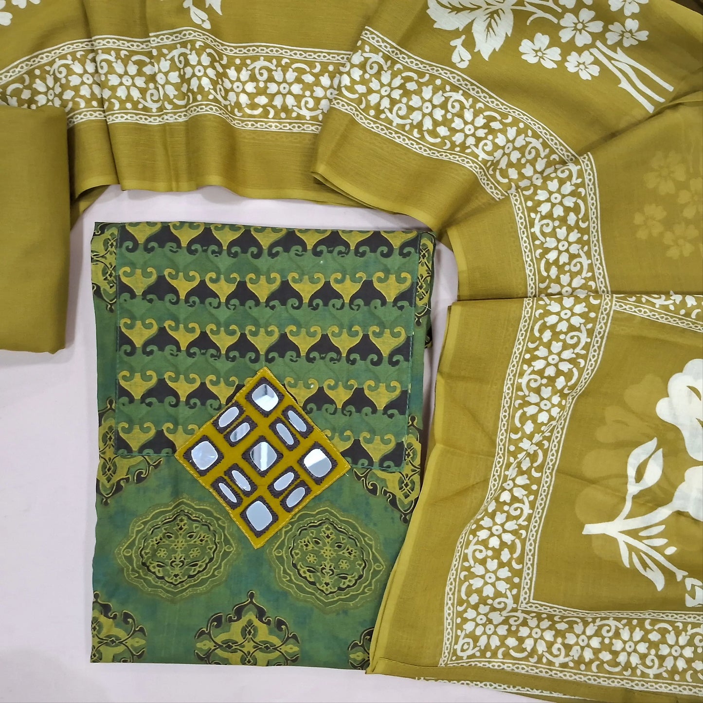 Light and dark shaded green ajrak hand block printed pure cotton unstitched salwar material, real mirror on yoke,(lining needed) mehandhi green cotton bottom,printed soft mul cotton dupatta. JN261409