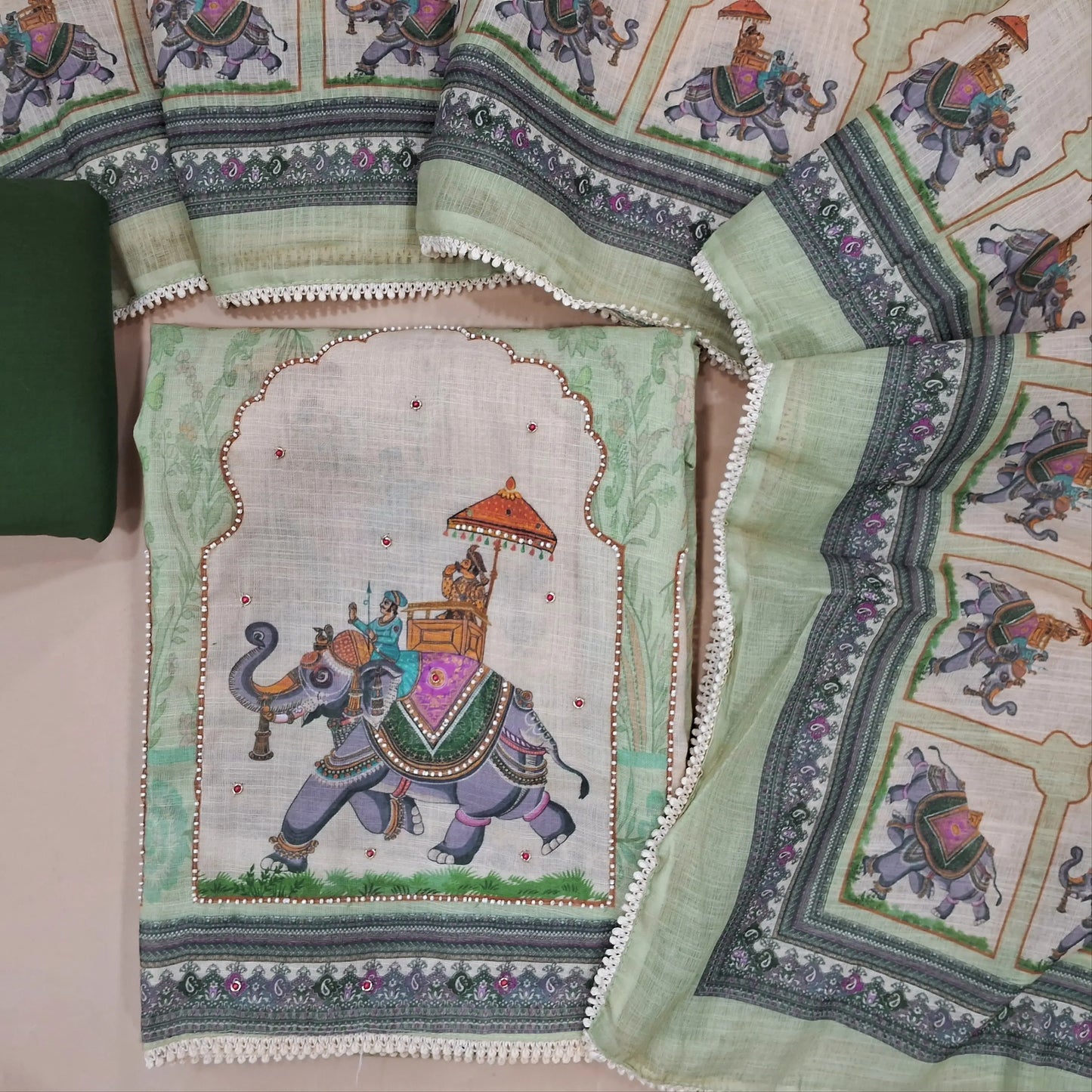 Pastel green digital printed semi linen unstitched salwar material, bead work on yoke and daman,(thin, lining needed)dark green bottom, digital printed semi linen dupatta. JN261405