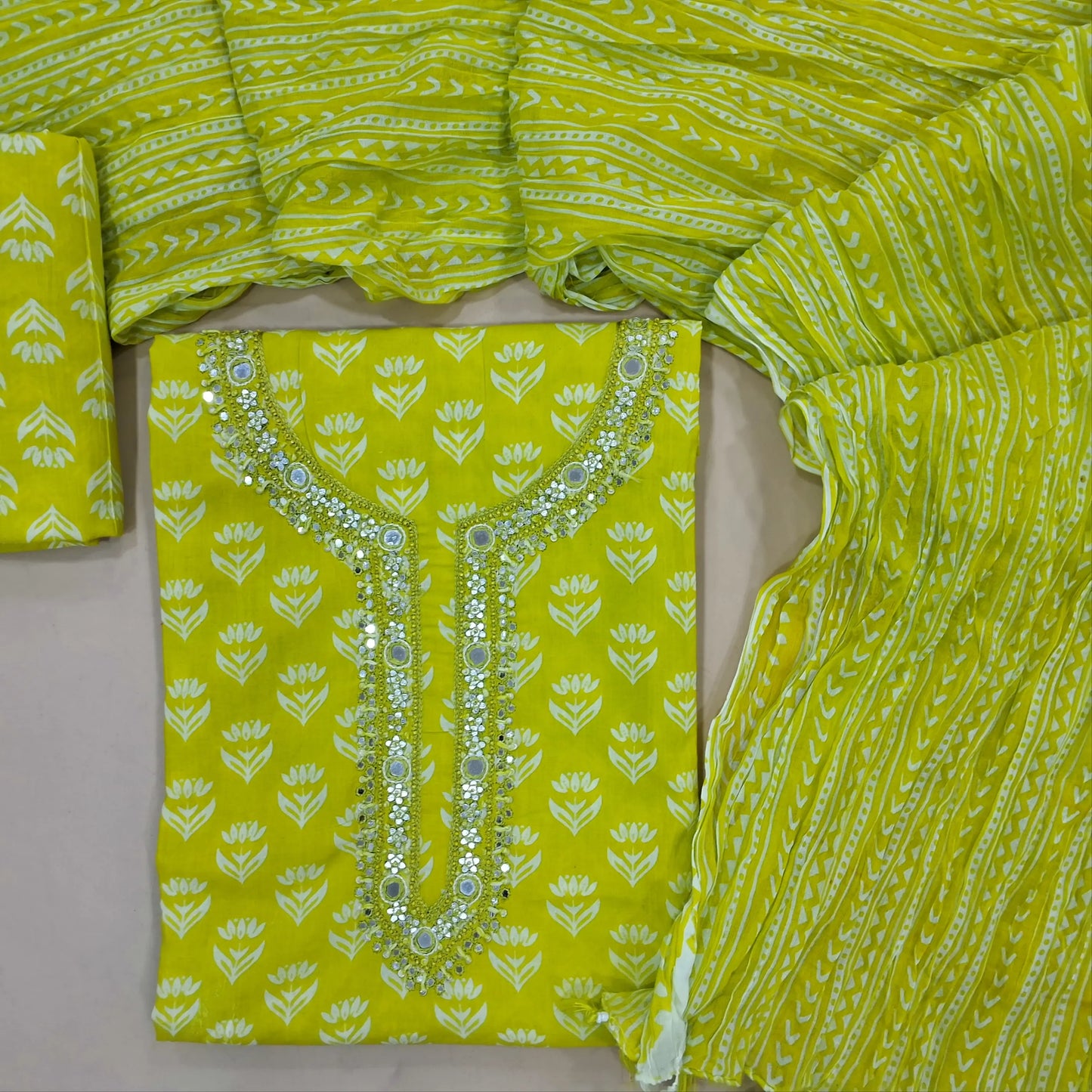 Bright green printed mul cotton unstitched salwar material, real mirror, french knot and faux mirror work on yoke,(lining needed) printed cotton bottom, crinkled printed mul cotton dupatta. JN261402