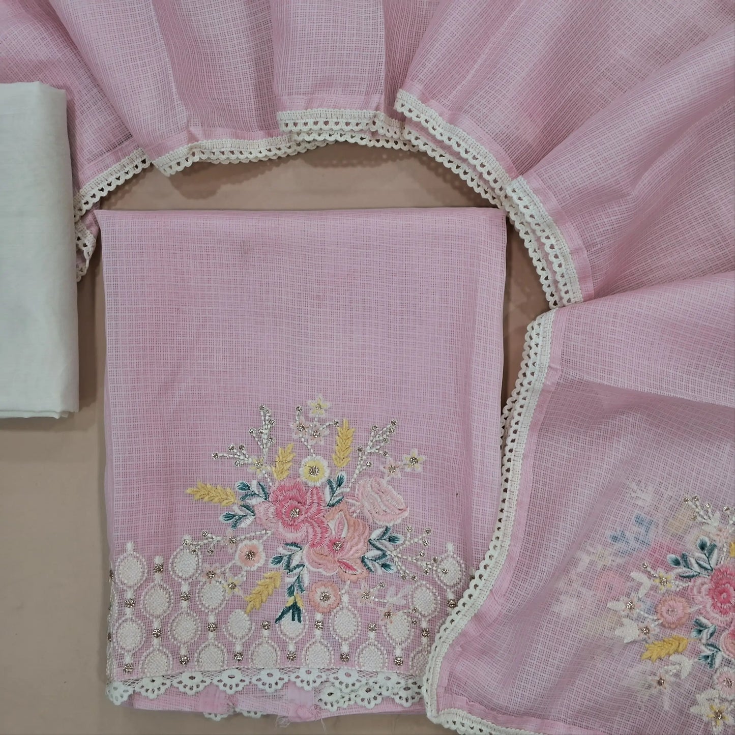 Pastel Pink kota unstitched salwar material (lining needed) embroidered yoke,rich embroidery and lace detailing on daman, off white cotton bottom, embroidery work on kota dupatta with lace work. JN261418