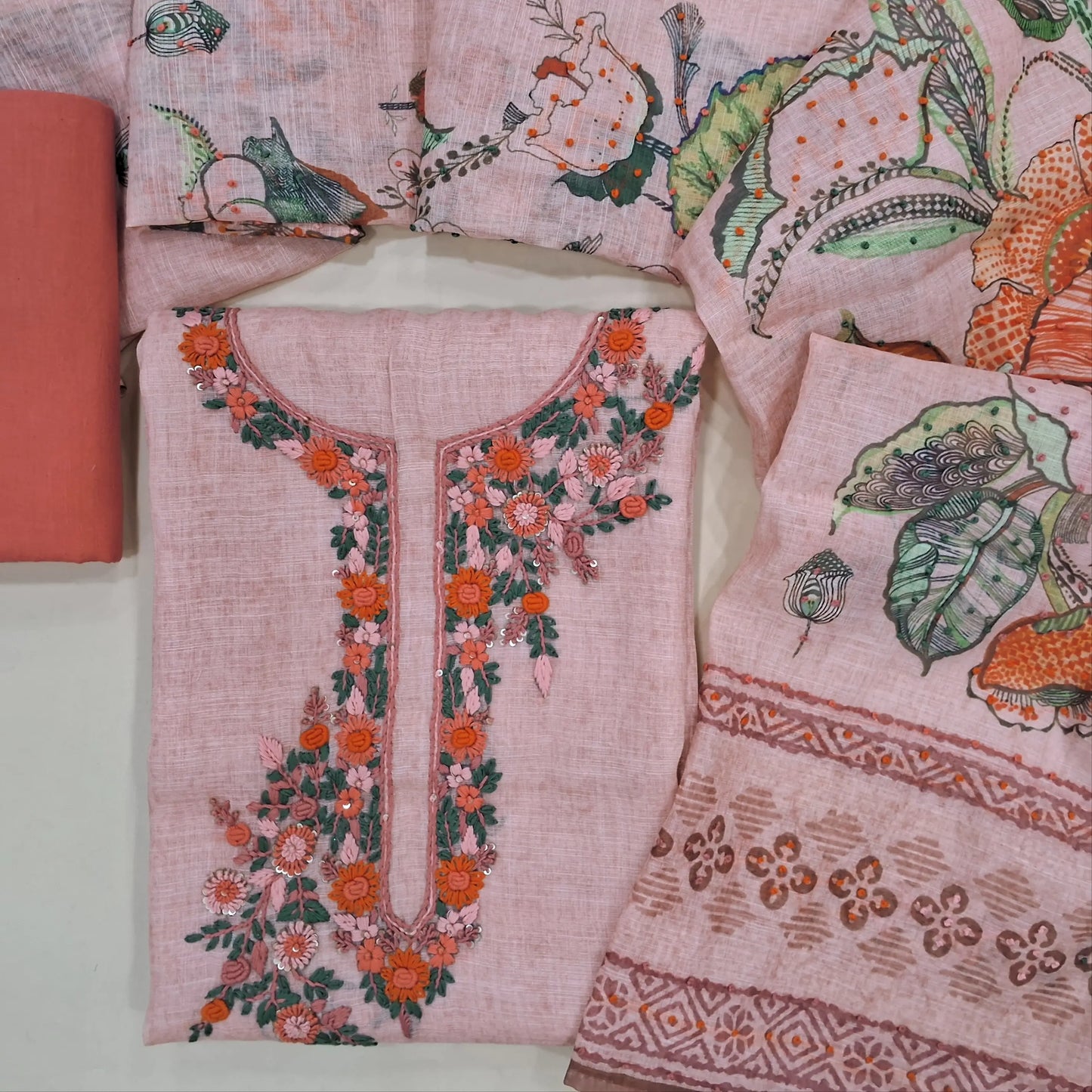 Peachish pink premium linen unstitched salwar material(textured, lining needed) rich hand embroidery work on front, matching santoon bottom, digital floral printed, hand embroidery work on linen dupatta. JN261413