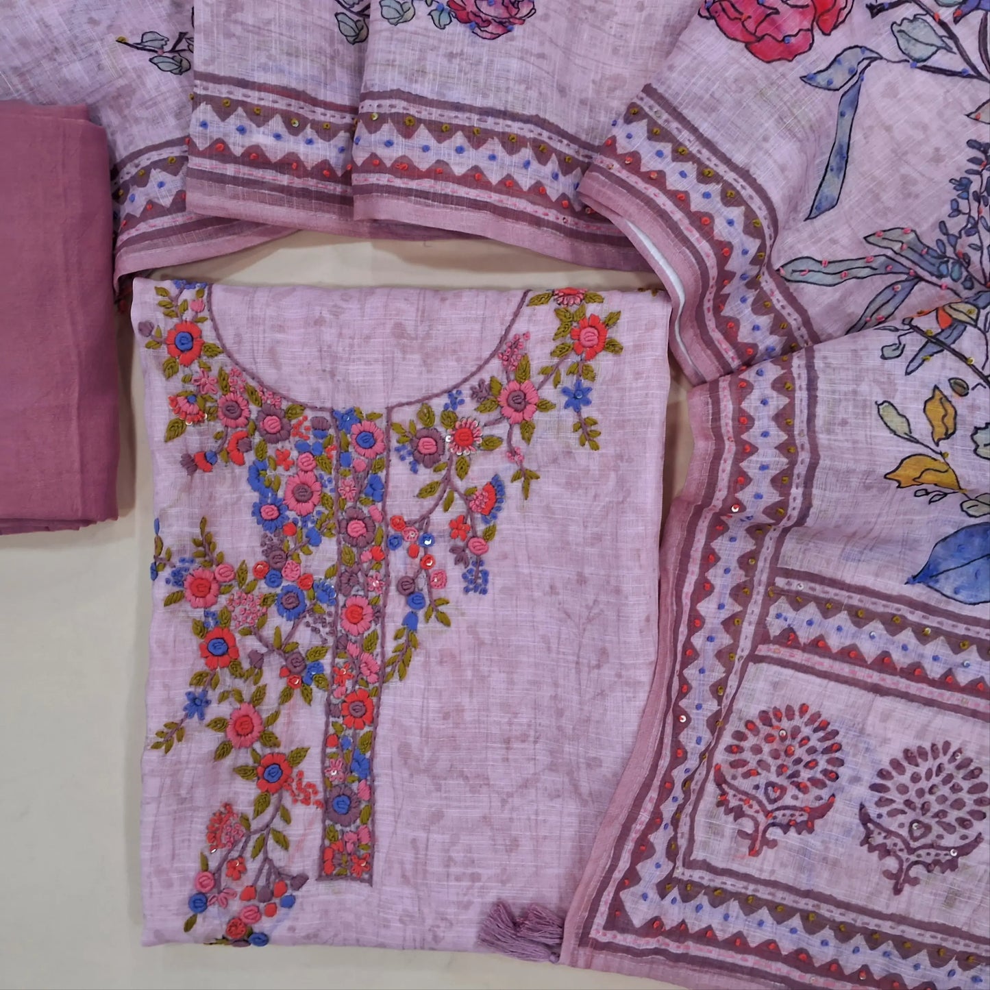 Pastel pink premium linen unstitched salwar material(textured, lining needed) rich hand embroidery work on front, matching santoon bottom, digital floral printed, hand embroidery work on linen dupatta. JN261412